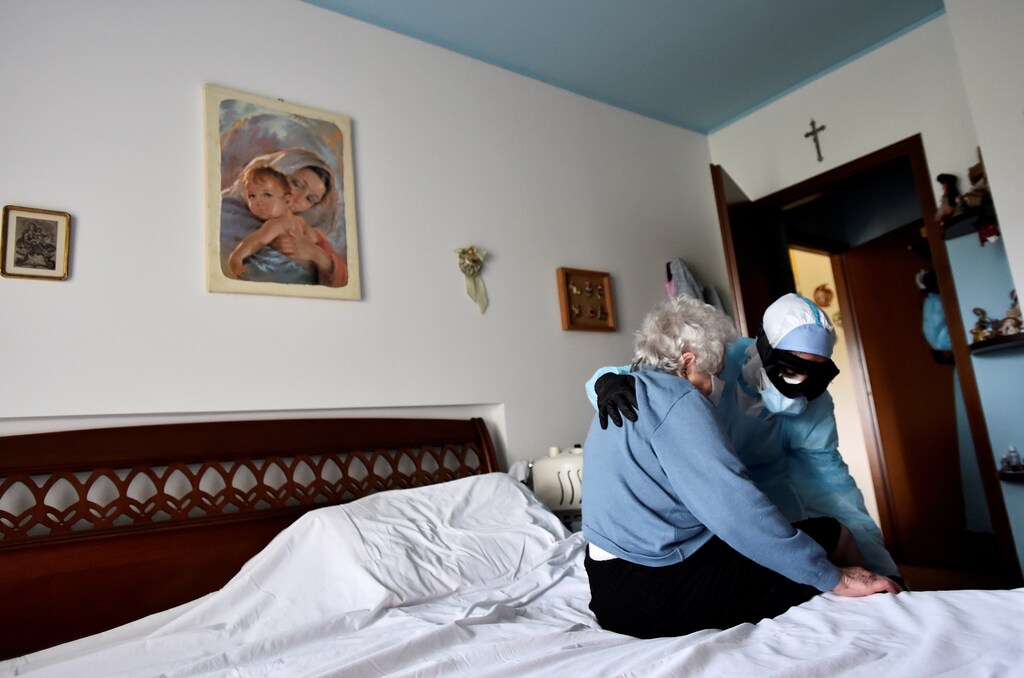 A doctor in protective suit visits the home of a person suffering from the coronavirus disease (COVID-19) in Bergamo, the epicentre of Italy's outbreak, April 16, 2020. Patients with symptoms that are not too severe are treated at home in Bergamo, to avoid overcrowding hospitals already overwhelmed with patients needing intensive care