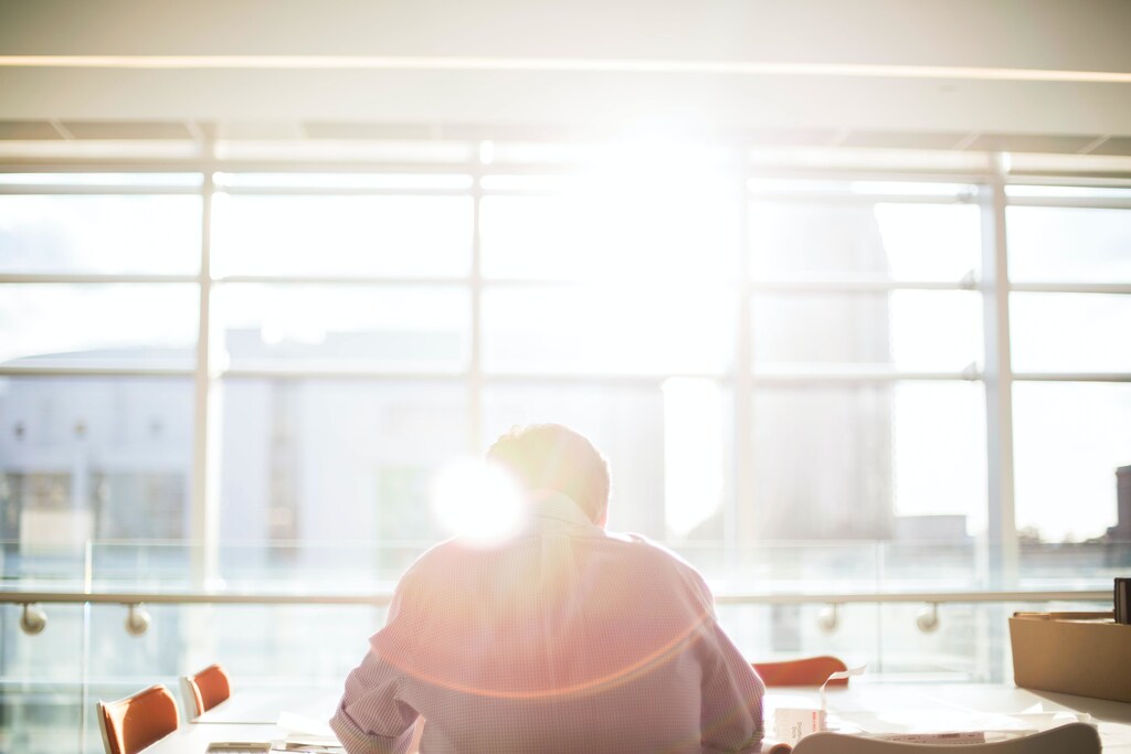 if possible, finding a quiet space to work in the office is one method of avoiding distraction, like this man here