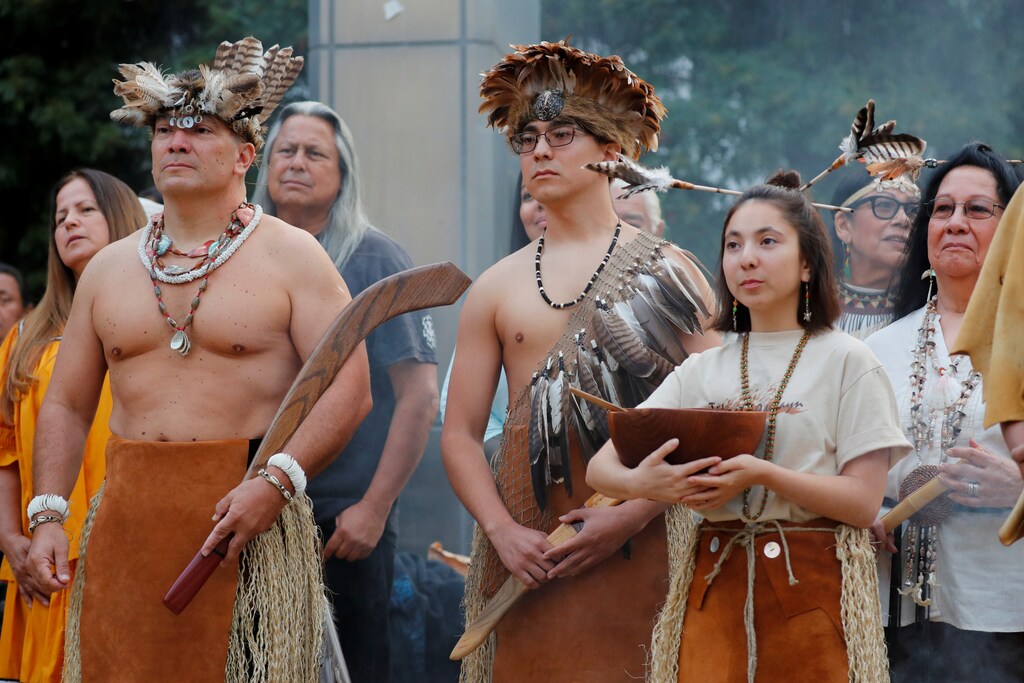 Kevin Nunez (L) and his son Nathan of the Gabrielino-Tongva tribe take part in a sunrise ceremony after Los Angeles City Council voted to establish the second Monday in October as "Indigenous People's Day", replacing Columbus Day, in Los Angeles, California, U.S., October 8, 2018. REUTERS/Mike Blake - RC17571B9800