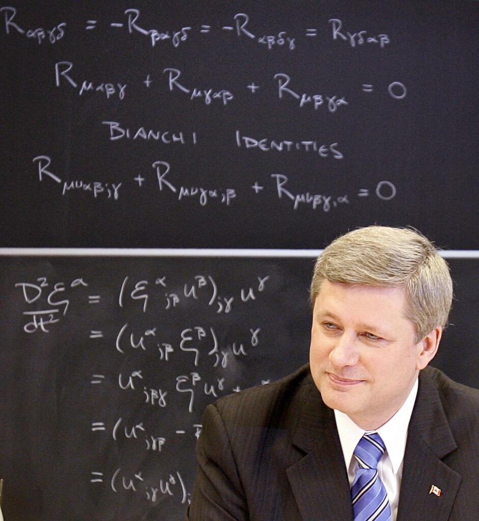 Canadian Prime Minister Stephen Harper sits in front of a blackboard containing mathematical equations while announcing a funding boost for science and technology at the Perimeter Institute for Theoretical Physics in Waterloo, May 17, 2007. REUTERS/J.P. Moczulski (CANADA) - GM1DVGYIALAA