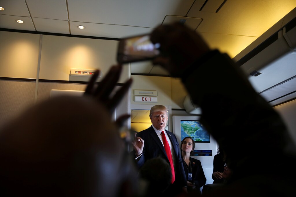 U.S. President Donald Trump talks to journalists members of the travel pool on board the Air Force One during his trip to Palm Beach, Florida while flying over South Carolina, U.S., February 3, 2017. REUTERS/Carlos Barria - RTX2ZK0K