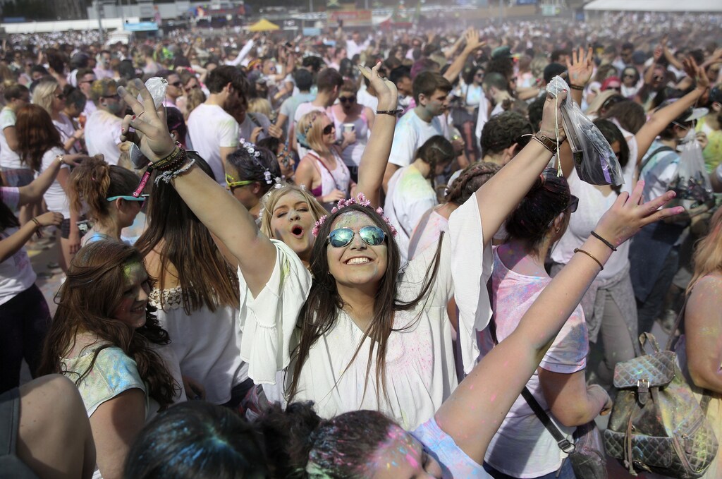 Revellers take part in the Holi Festival of Colours in London, Britain.