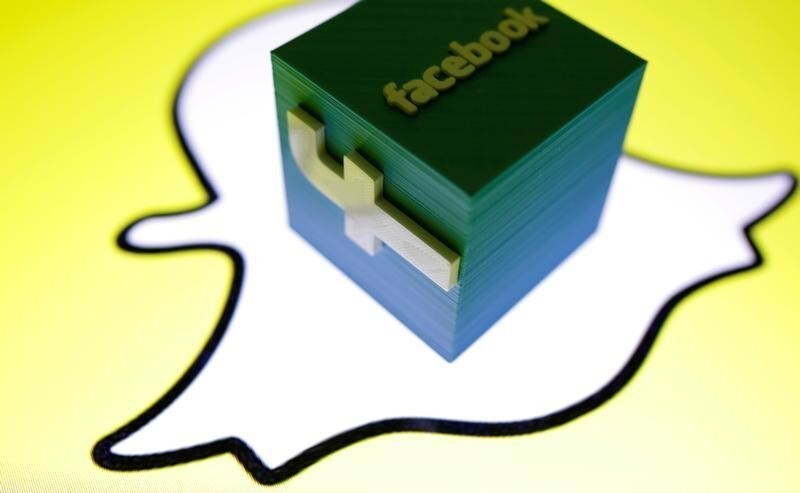 A 3D printed Facebook logo is seen in front of a displayed Snapchat logo in this picture illustration taken August 11, 2017. REUTERS/Dado Ruvic/Illustration - RC1C28141320