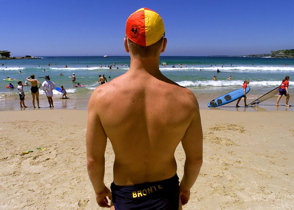 Lifesaver Paul Booth watches swimmers between the flagged area at Sydney's famous Bondi Beach December 20, 2000. With about 60 million visitors using Australia's more than 7,000 accessible beaches each year, a recent poll has found that only 44 percent of Australians will swim between the flags marking the area patrolled by lifesavers, with males being twice as likely as females to swim outside the designated area. The Surf Life Saving Australia is one of the largest volunteer organsiations in the world, whose 98,000 members rescued over 10,000 people last summer on Australian beaches, and gave out 252,000 individual warnings to swimmers, an increase of 40 percent on last year. BLIFE NO RIGHTS CLEARANCES OR PERMISSIONS ARE REQUIRED FOR THIS IMAGE REUTERS/DAVID GRAY DG/JD AUSTRALIA - RP2DRHYJTDAB