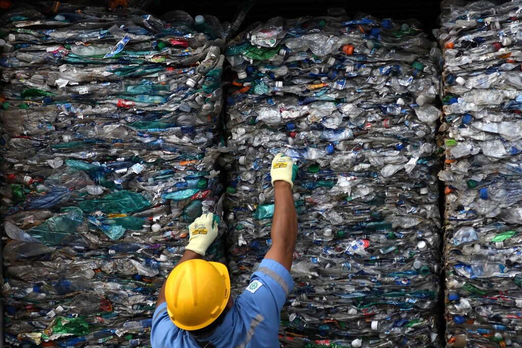 An officer shows a container full with plastic waste at Tanjung Priok port in Jakarta, Indonesia, September 18, 2019 in this photo taken by Antara Foto. Antara Foto/Aditya Pradana Putra/Handout via REUTERS. ATTENTION EDITORS - THIS IMAGE WAS PROVIDED BY A THIRD PARTY. MANDATORY CREDIT. INDONESIA OUT. - RC1F94DF8000