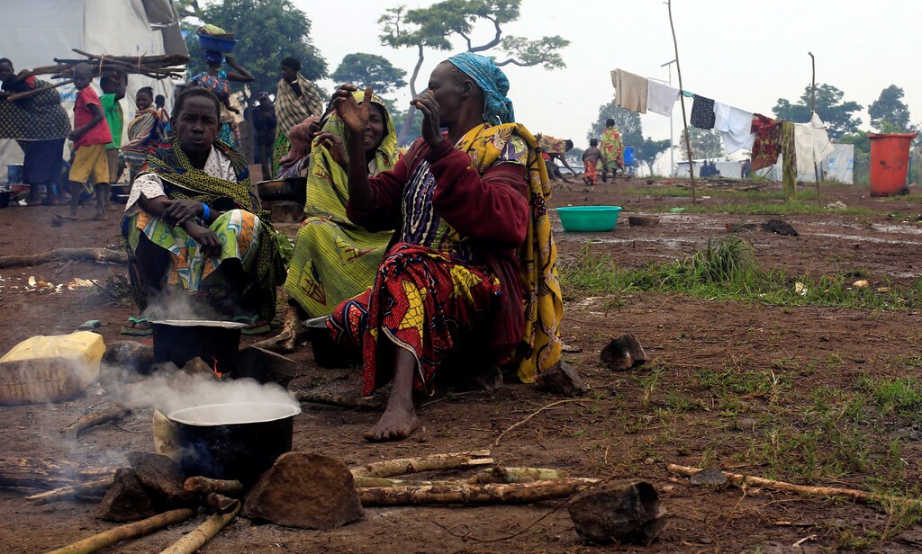 Congolese families, who fled from Democratic Republic of Congo by fleeing on a boat across Lake Albert, prepare meals at United Nations High Commission for Refugees' (UNHCR) Kyangwali refugee settlement camp.