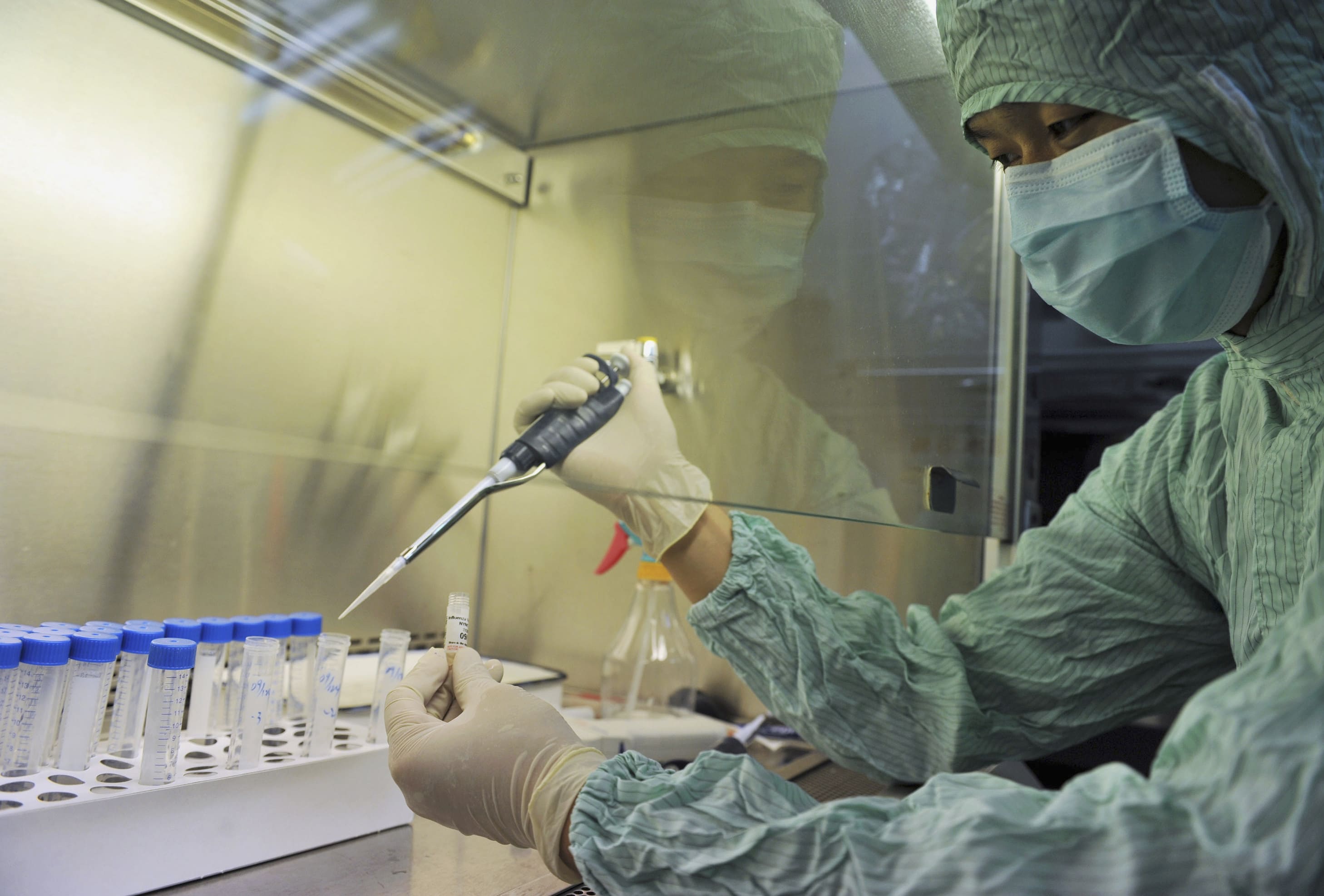 A technician works in the inoculation area during preparations to produce vaccines for the H1N1 flu virus at a lab in Wuhan, Hubei province June 17, 2009. Chinese vaccine maker Sinovac Biotech Ltd hopes to put its H1N1 vaccine through its first clinical trial by the end of July, as pharmaceutical firms race to put vaccines against the new flu virus into commercial production. Thousands of chicken eggs were readied to grow the H1N1 virus on Monday, after the World Health Organization declared a pandemic last Thursday and warned governments to prepare for a long battle against the virus. Picture taken June 17, 2009. REUTERS/China Daily (CHINA HEALTH SOCIETY SCI TECH BUSINESS) CHINA OUT. NO COMMERCIAL OR EDITORIAL SALES IN CHINA - GM1E56I0YHF01