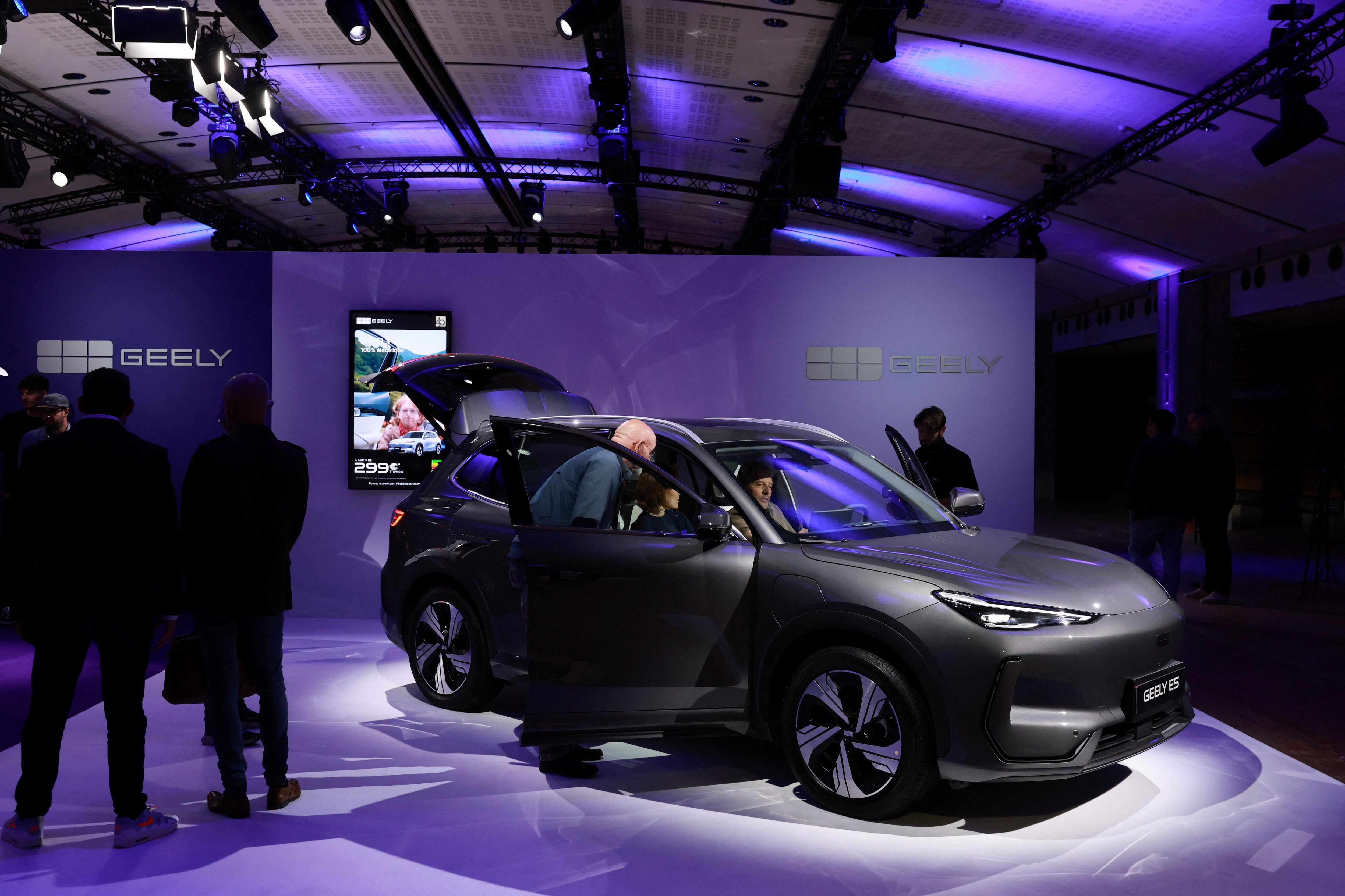 Journalists look at the Geely E5 electric compact SUV car presented during a press conference for the launching of Geely Auto France, in Paris, France, April 28, 2026. REUTERS/Stephanie Lecocq
