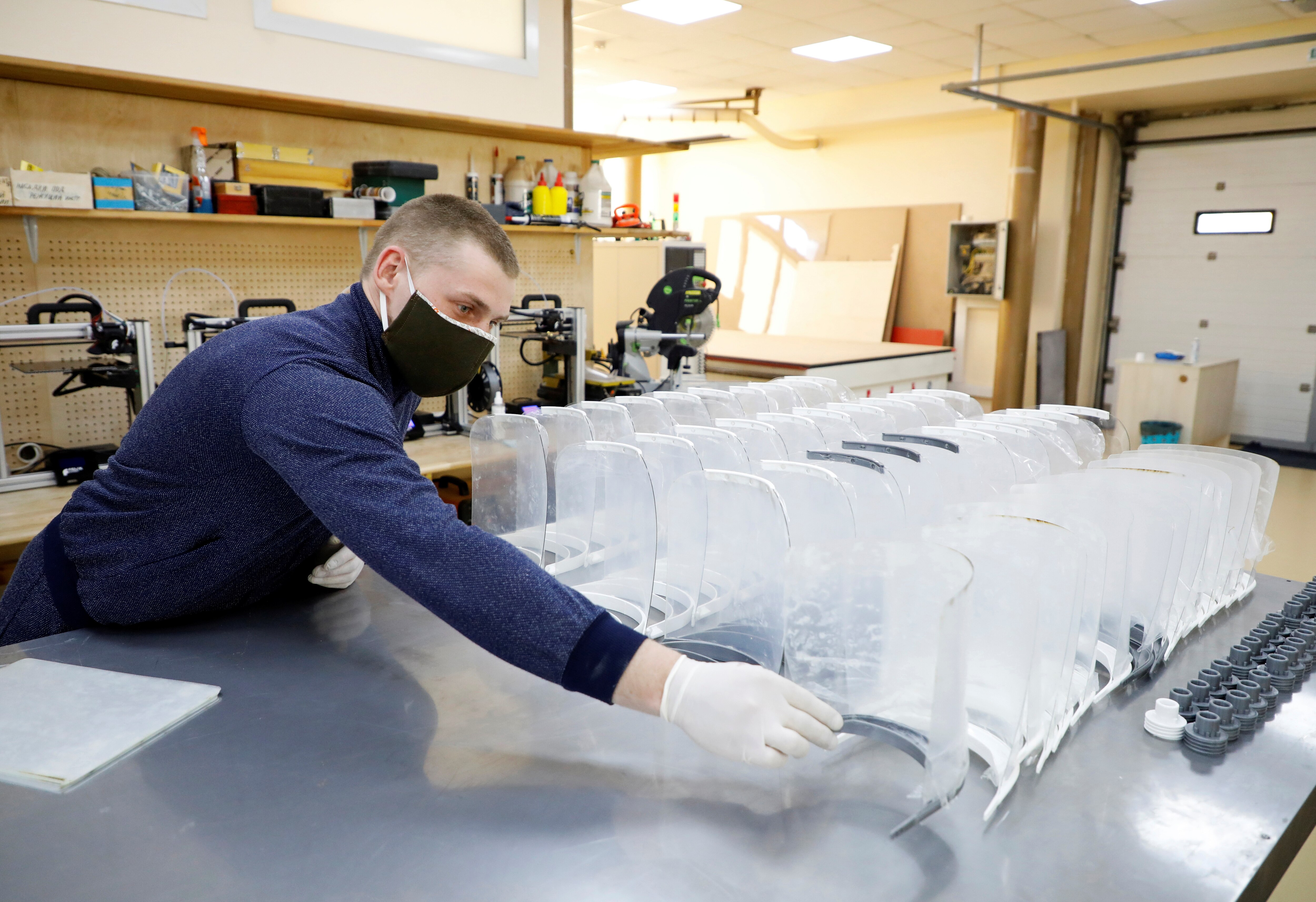 A volunteer examines face shields, components of which were manufactured on a 3D printer at the laboratory of the Agrarian University in Stavropol, Russia April 17, 2020. Volunteers across the country use 3D printing to make components of the protective face shields, masks and ventilators to be used by medical professionals in the fight against the coronavirus disease (COVID-19). REUTERS/Eduard Korniyenko - RC2J6G9IWIDH