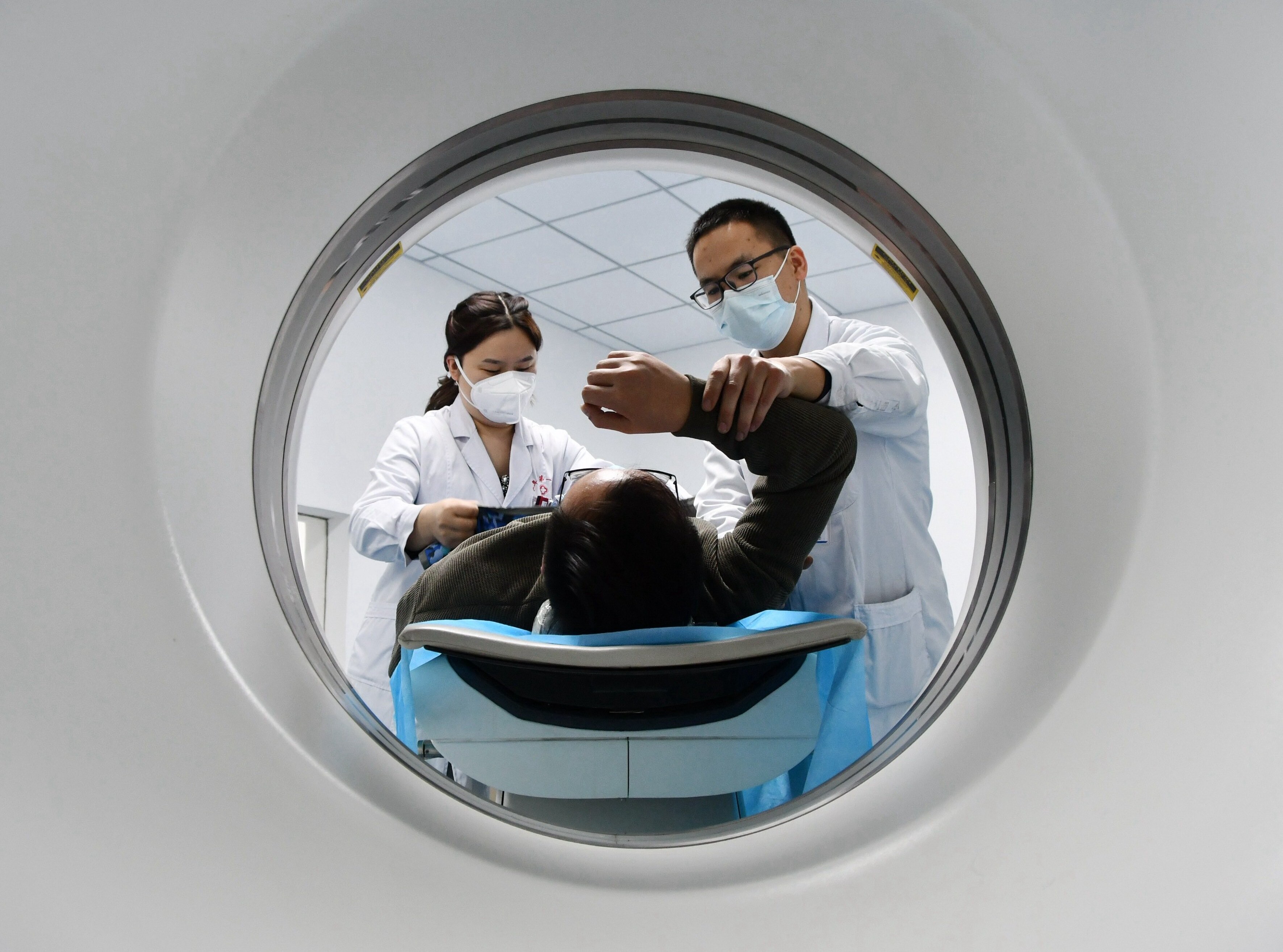 Photo by Costfoto/NurPhoto/Shutterstock (14932502d) A medical worker performs a CT examination on a patient in Handan, Hebei province, China, on January 1, 2022. Medical Service Price, Handan, China - 21 Nov 2024