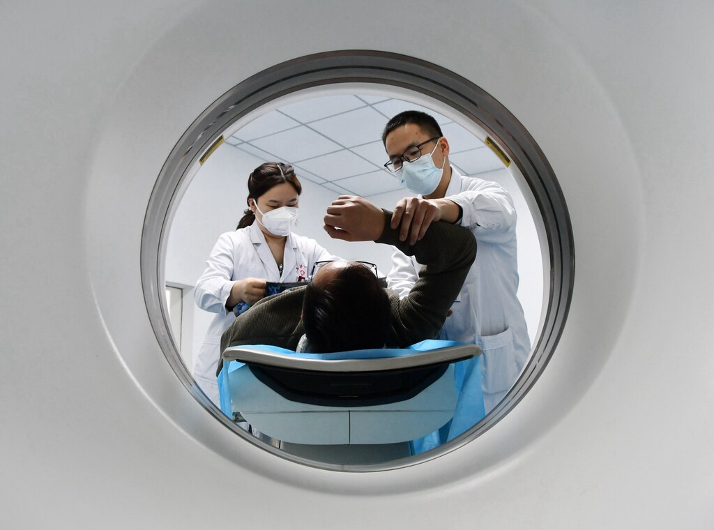 Photo by Costfoto/NurPhoto/Shutterstock (14932502d) A medical worker performs a CT examination on a patient in Handan, Hebei province, China, on January 1, 2022. Medical Service Price, Handan, China - 21 Nov 2024