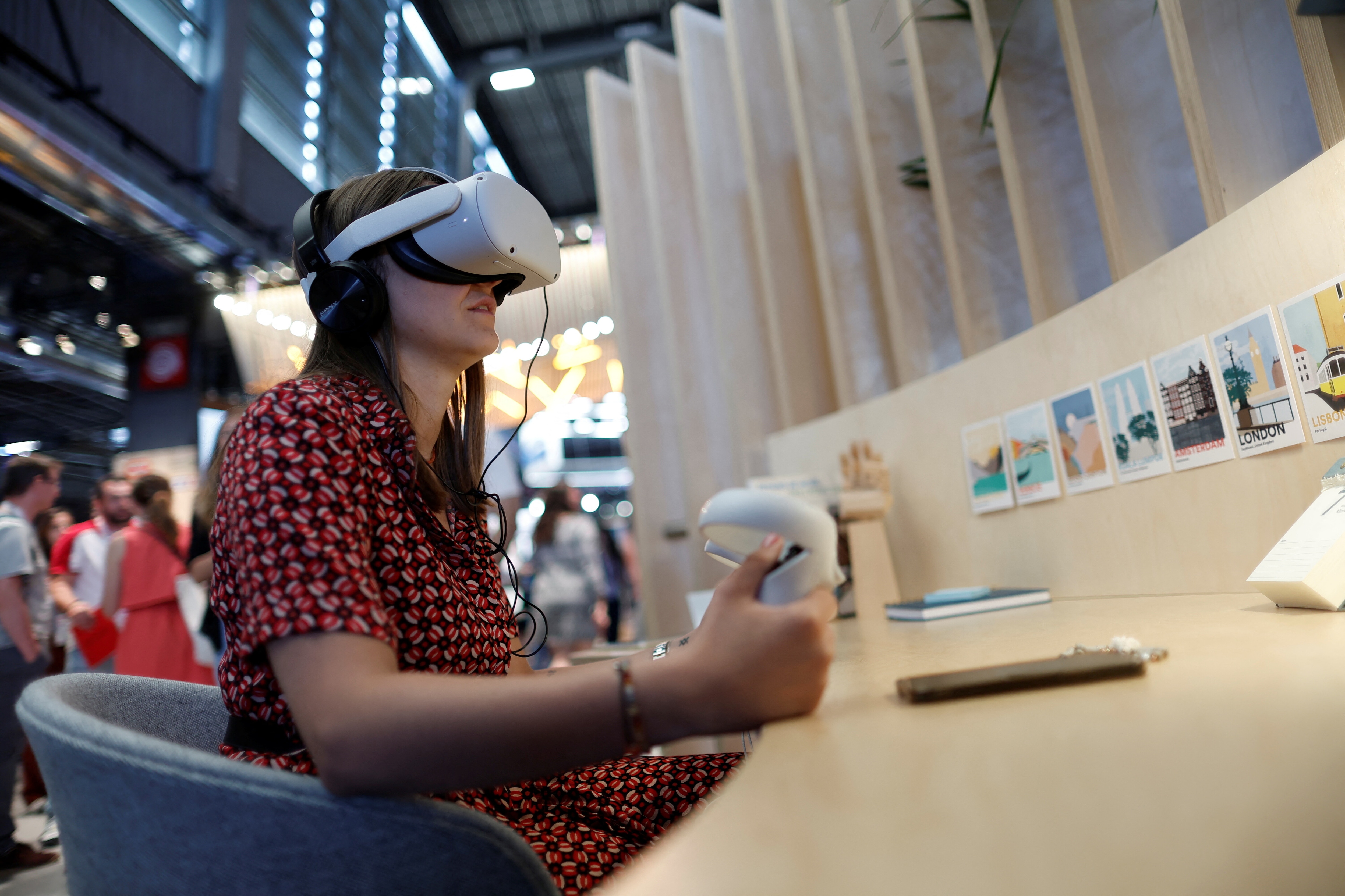 An attendee wearing a virtual reality (VR) headset tries out a VR application on the Meta Platforms Inc. booth at the Viva Technology conference dedicated to innovation and startups at Porte de Versailles exhibition center in Paris, France June 16, 2022. REUTERS/Benoit Tessier