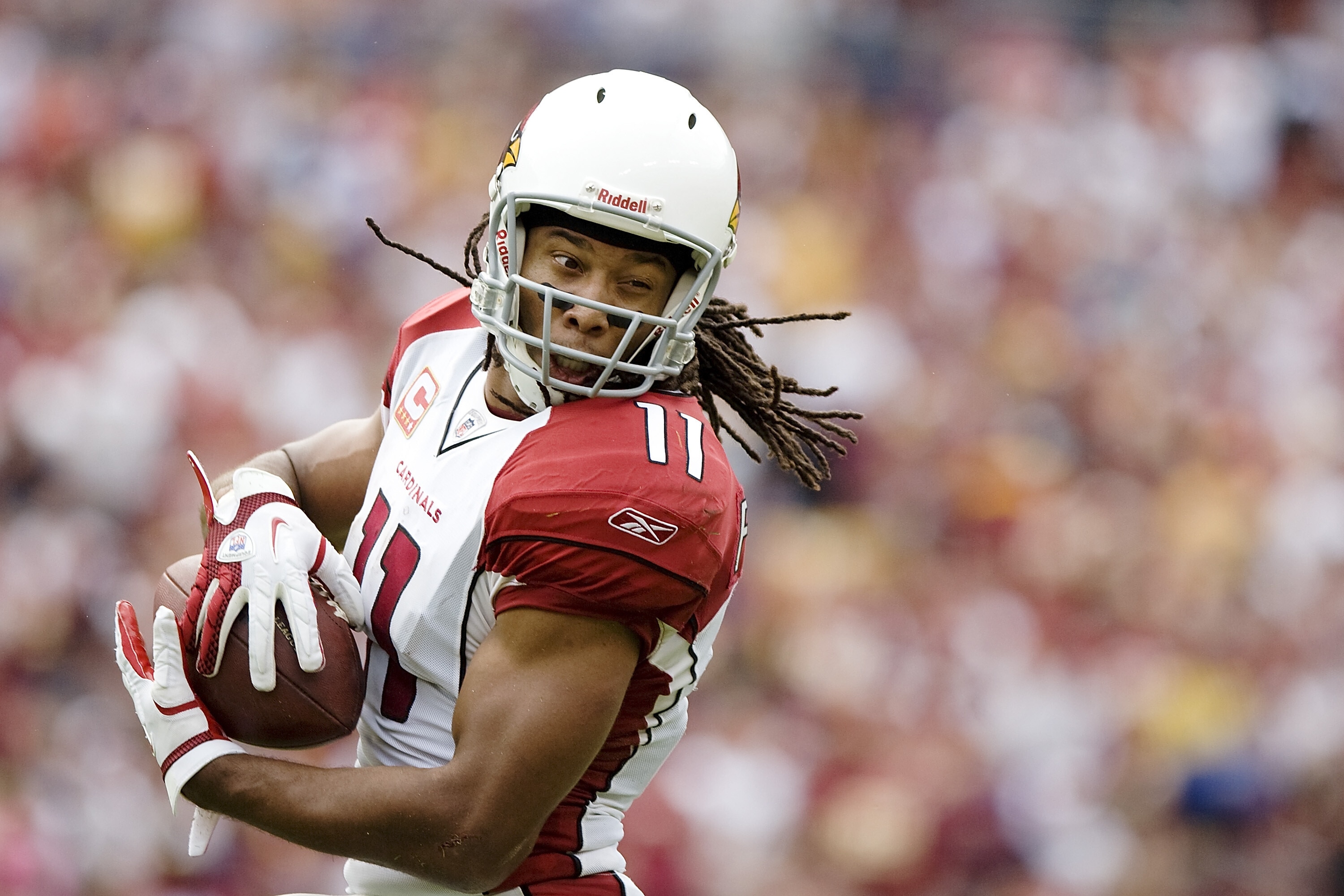 Arizona Cardinals receiver Larry Fitzgerald (11) pulls in a catch against the Washington Redskins during the second half of their NFL football game in Landover, Maryland, September 18, 2011