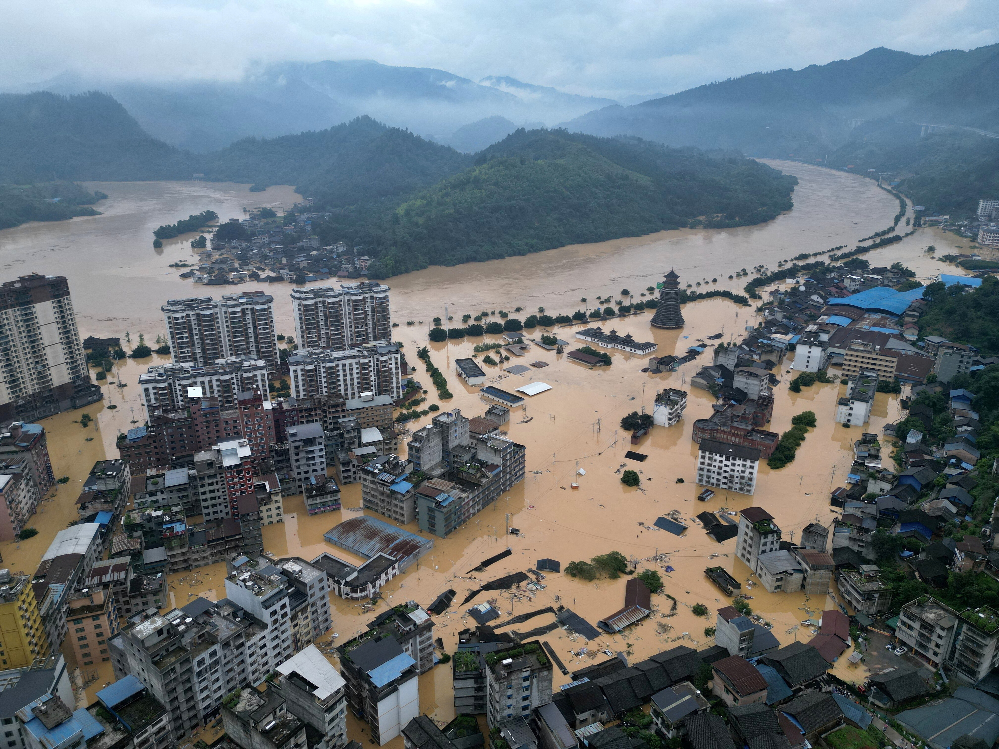 A drone view shows buildings and roads are half submerged in floodwaters after heavy rainfalls, in Rongjiang county, Guizhou province, China.