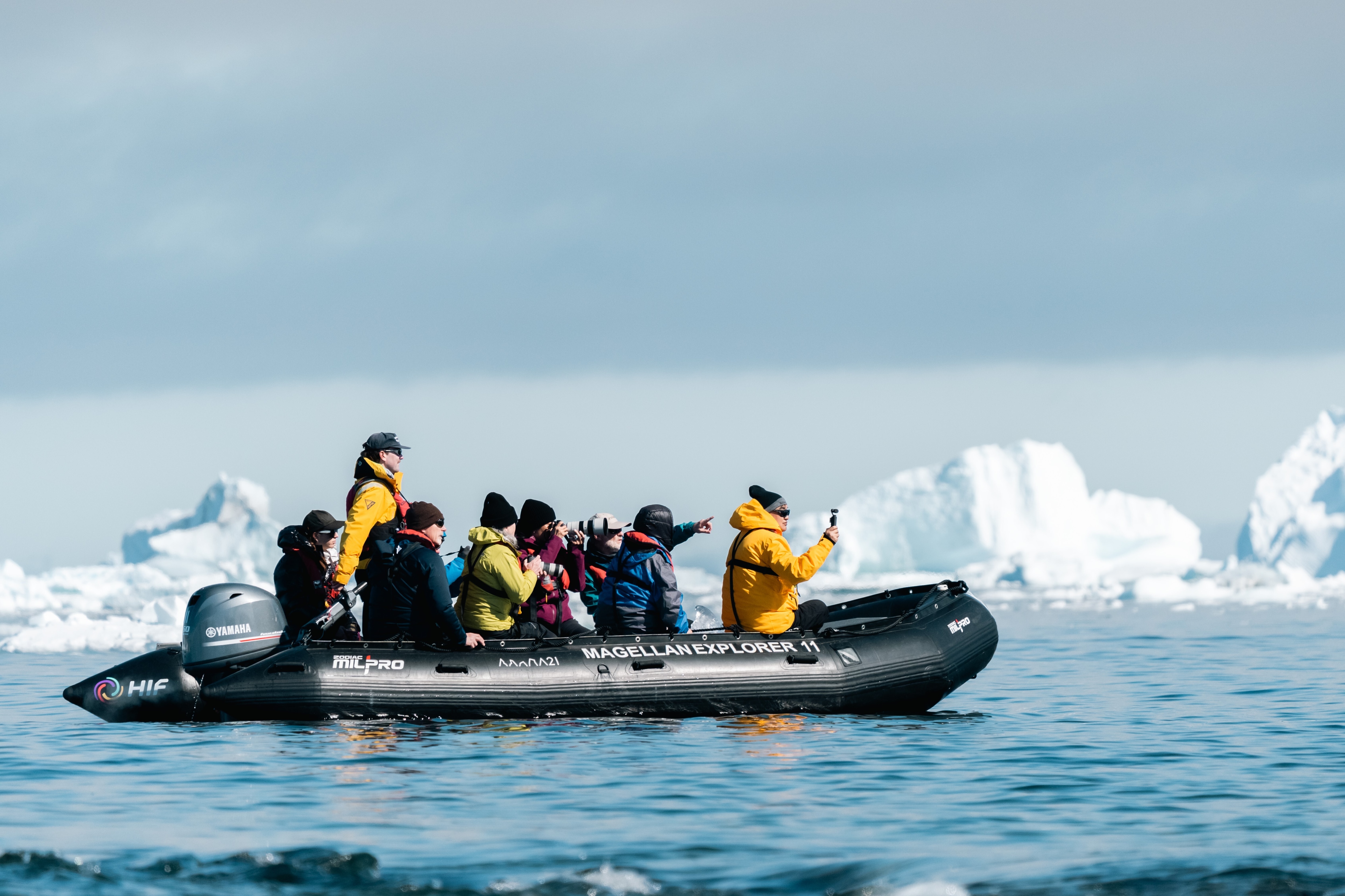 A group of tourists on an expedition in Antarctica. The motorboat uses e-fuels to make tourism more sustainable