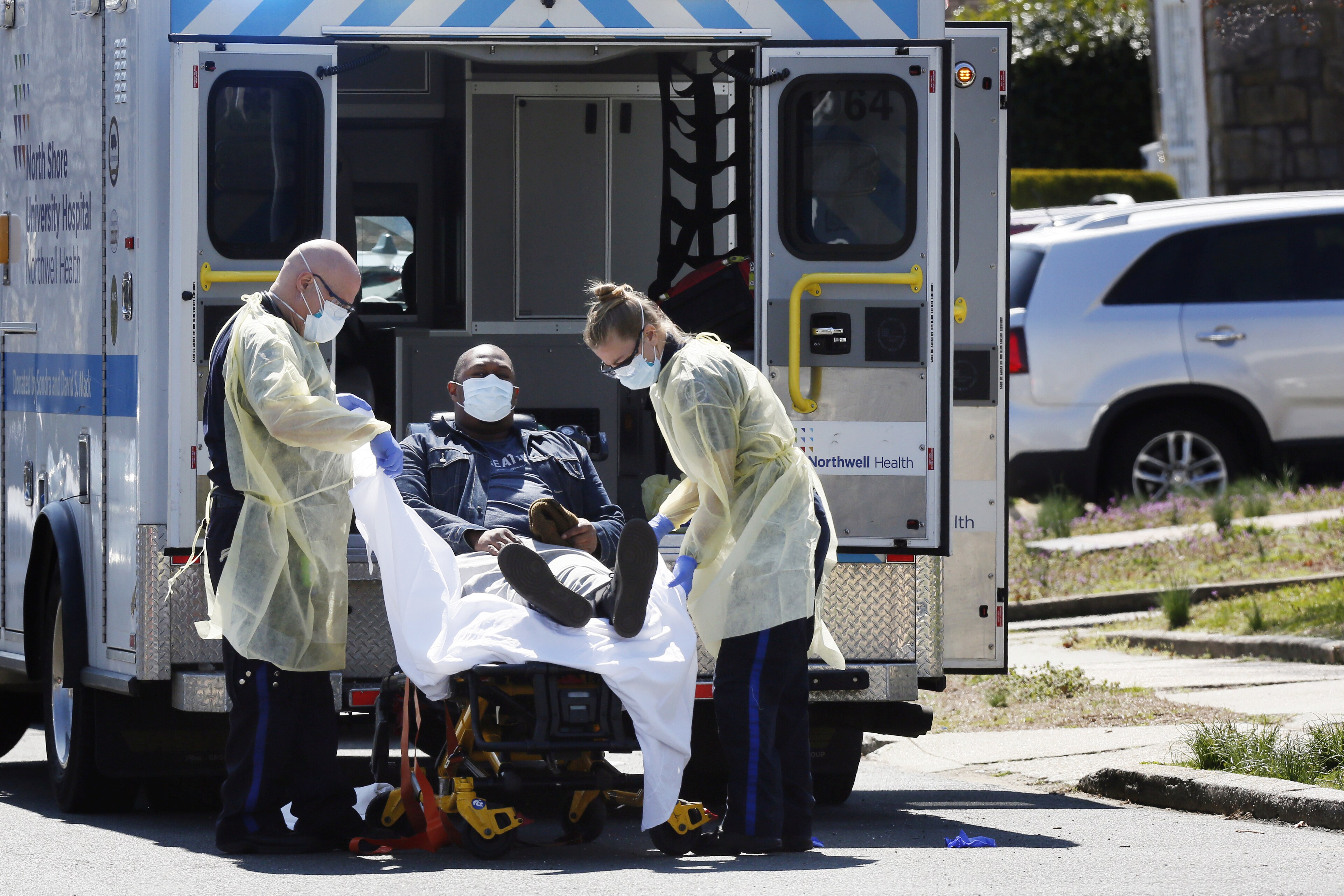 Emergency Medical Technicians (EMT) lift a patient that was identified to have coronavirus disease (COVID-19) into an ambulance while wearing protective gear, as the outbreak of coronavirus disease (COVID-19) continues, in New York City, New York, U.S., March 26, 2020.  REUTERS/Stefan Jeremiah - Coronavirus china virus health healthcare who world health organization disease deaths pandemic epidemic worries concerns Health virus contagious contagion viruses diseases disease lab laboratory doctor health dr nurse medical medicine drugs vaccines vaccinations inoculations technology testing test medicinal biotechnology biotech biology chemistry physics microscope research influenza flu cold common cold bug risk symptomes respiratory china iran italy europe asia america south america north washing hands wash hands coughs sneezes spread spreading precaution precautions health warning covid 19 cov SARS 2019ncov wuhan sarscow wuhanpneumonia  pneumonia outbreak patients unhealthy fatality mortality elderly old elder age serious death deathly deadly 