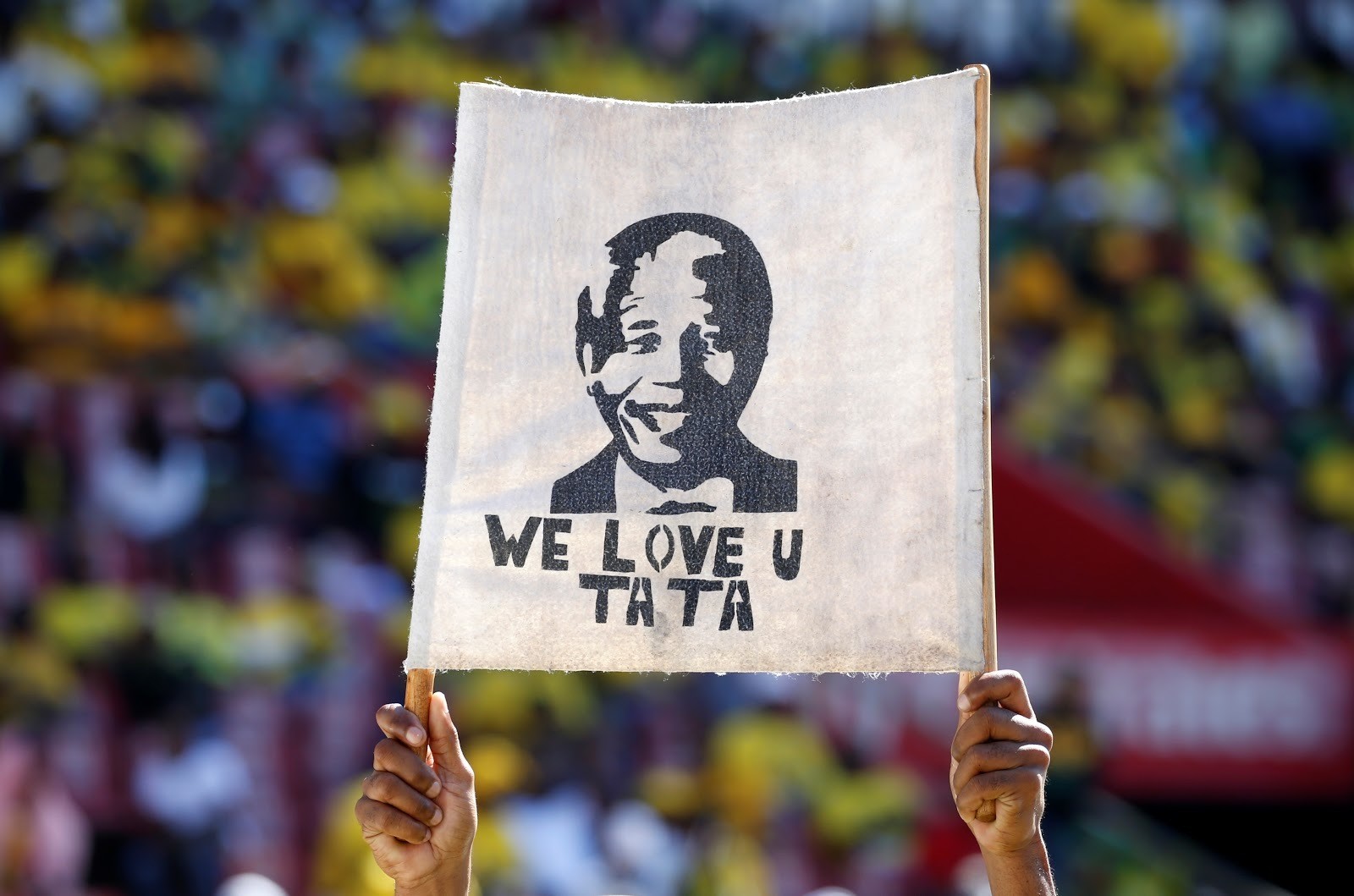 A supporter holds a placard with the face of the late Nelson Mandela during a rally in South Africa.