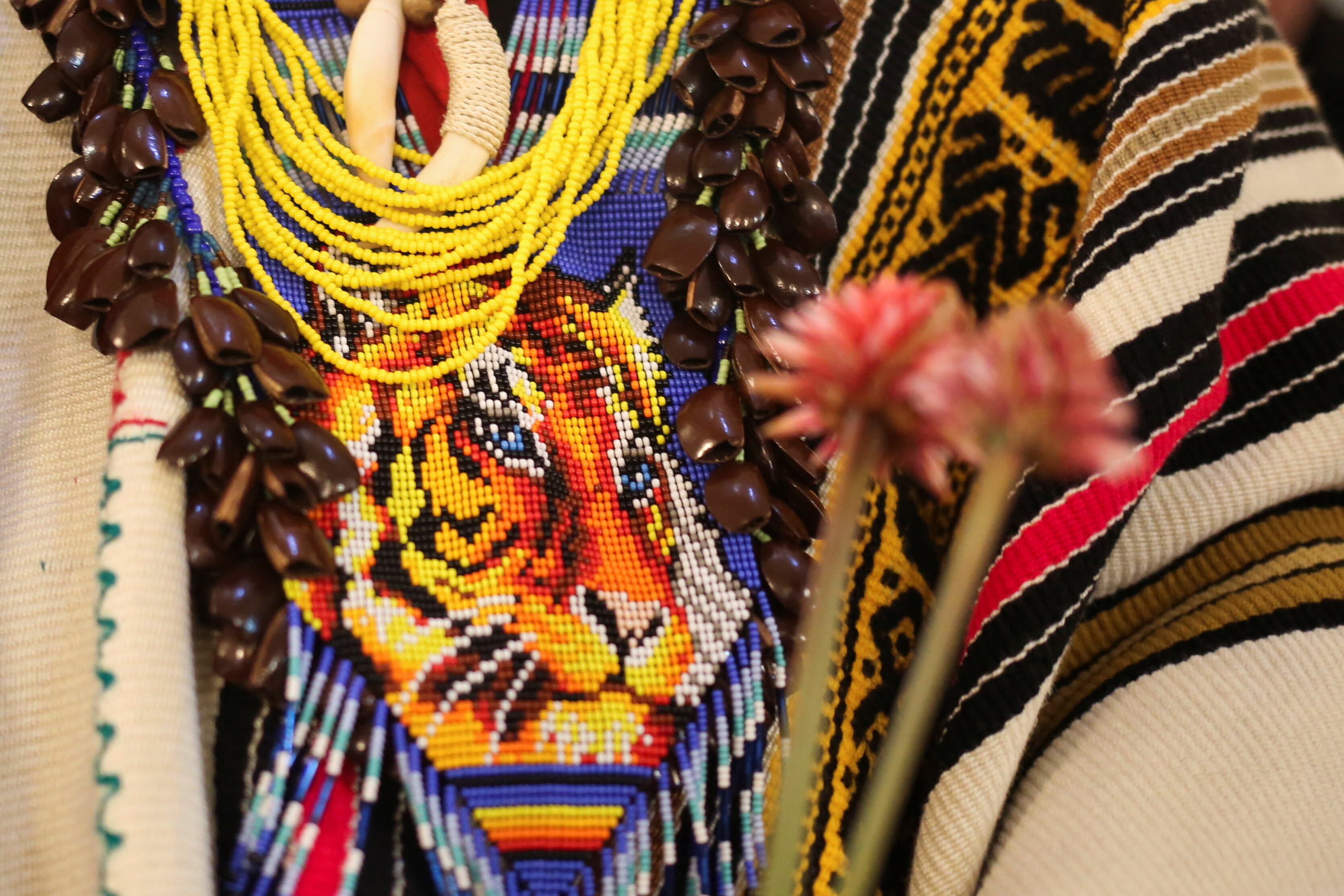 An indigenous man holds a bouquet of Inirida flowers, the flower that was chosen as the official image of the 16th United Nations Biodiversity Summit (COP16), during the inauguration and opening ceremony of the Maloka amazonica in the green zone of the 16th United Nations Biodiversity Summit (COP16), in Cali, Colombia October 21, 2024.