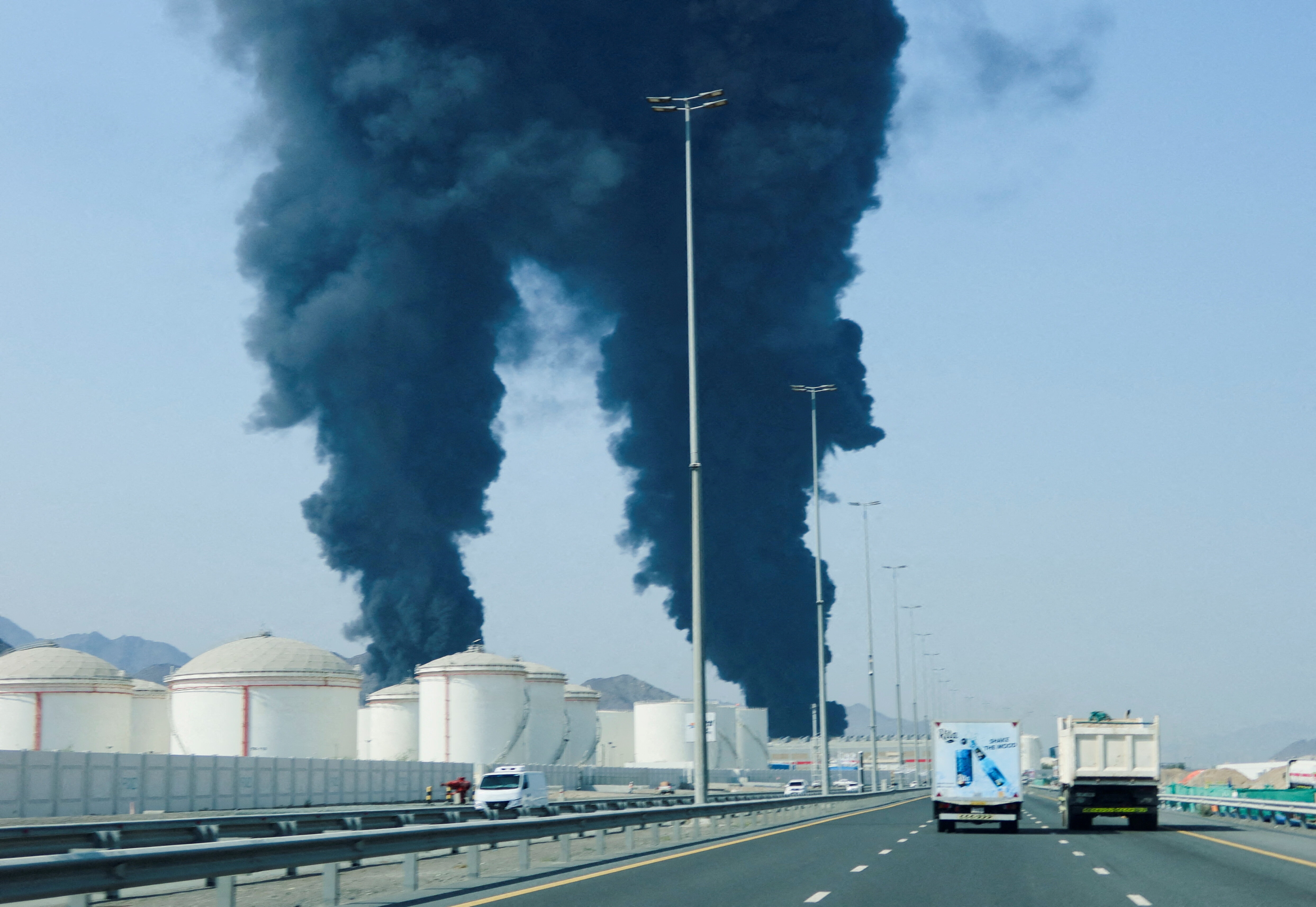 FILE PHOTO: Smoke rises in the Fujairah oil industry zone, caused by debris after interception of a drone by air defenses, according to the Fujairah media office, amid the U.S.-Israel conflict with Iran, in Fujairah, United Arab Emirates, March 14, 2026. REUTERS/Staff/File Photo