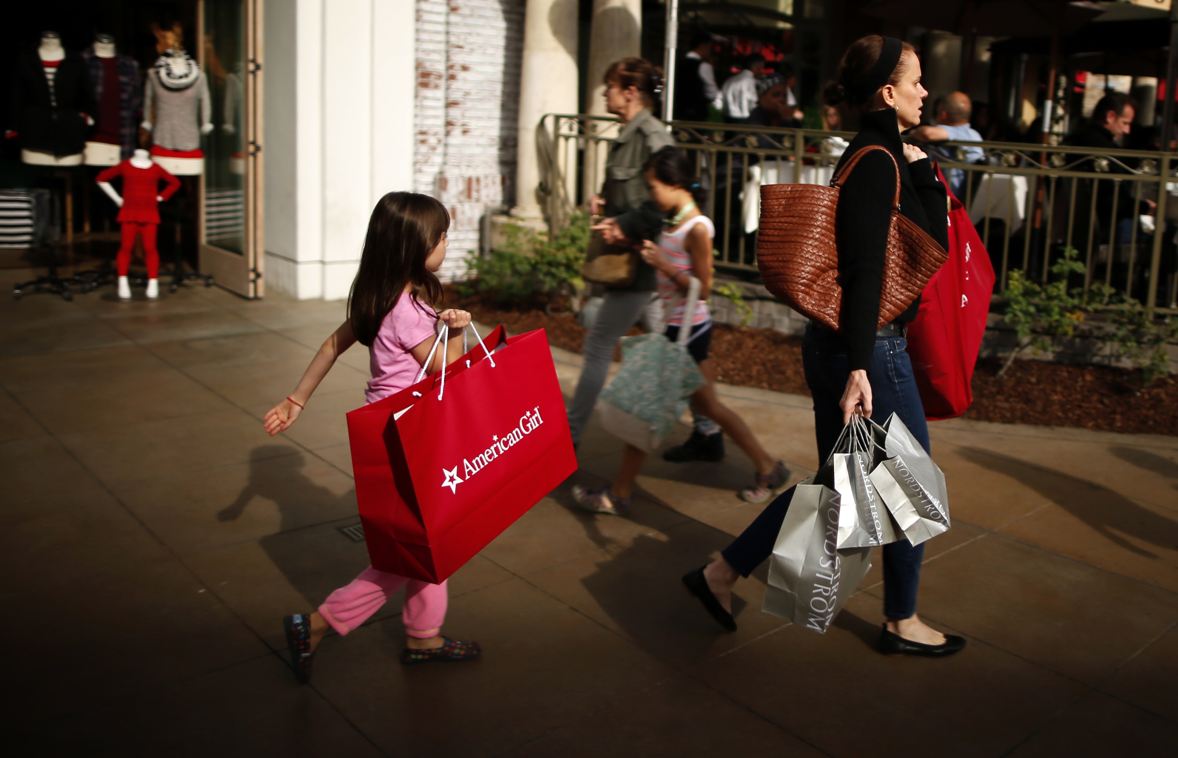 People shop at The Grove mall in Los Angeles November 26, 2013. This year, Black Friday starts earlier than ever, with some retailers opening early on Thanksgiving evening. About 140 million people were expected to shop over the four-day weekend, according to the National Retail Federation.     