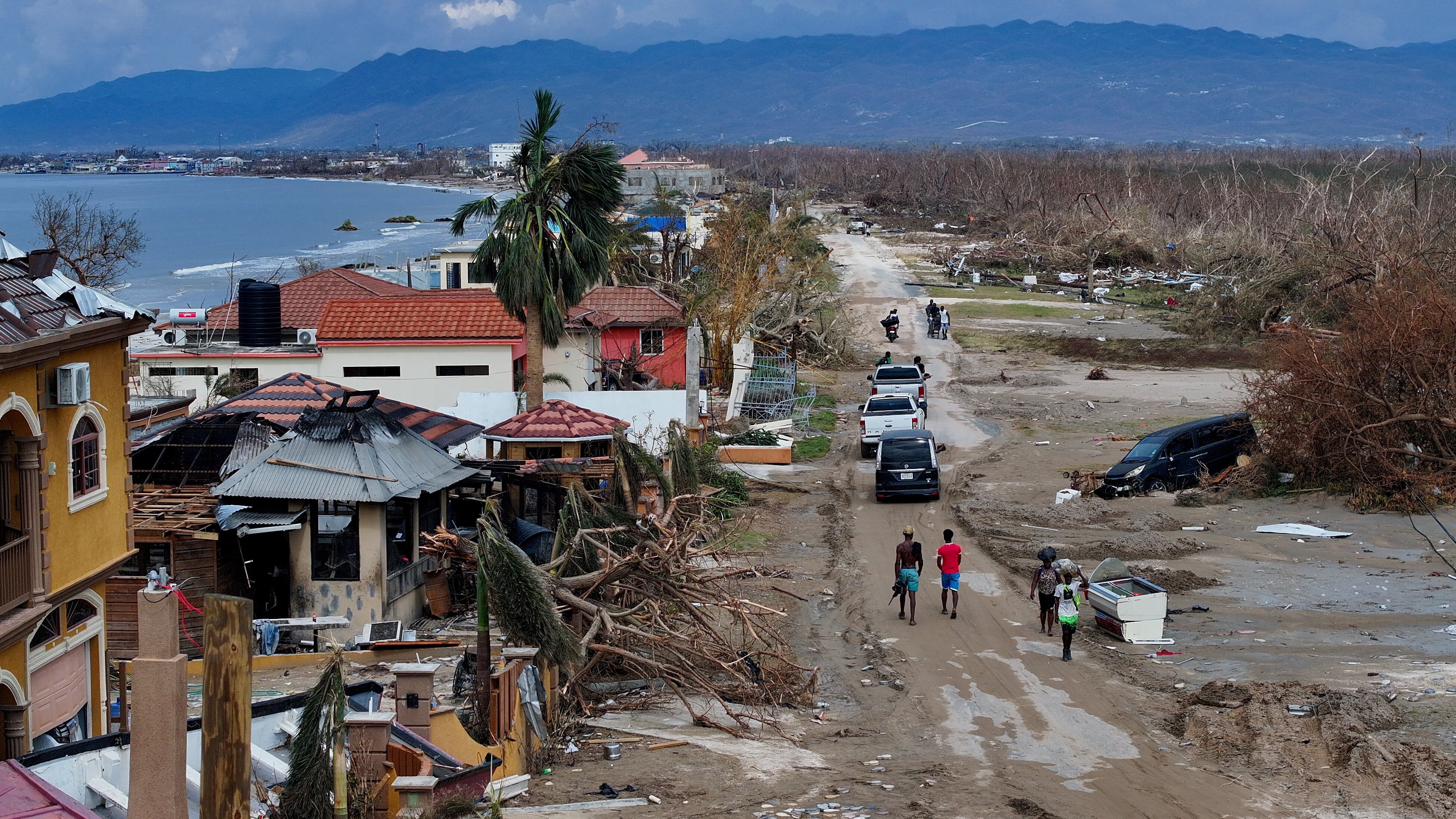 A drone view shows people walking in an affected area after Hurricane Melissa made landfall, in Crane Road, Black River, Jamaica, October 30, 2025.