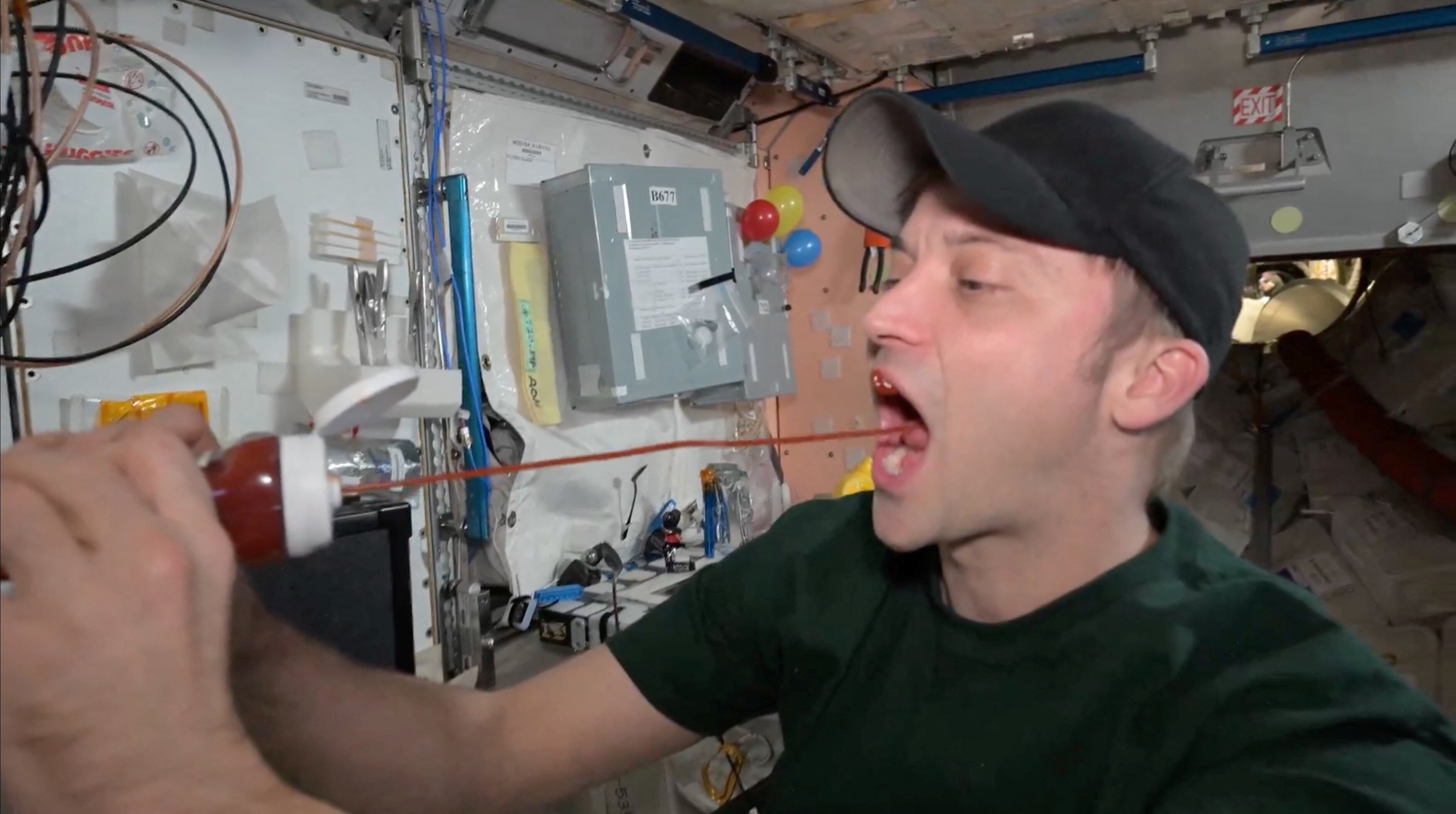 Astronaut Matthew Dominick eats ketchup in outer space, in this screen grab from a handout video released on October 22, 2024