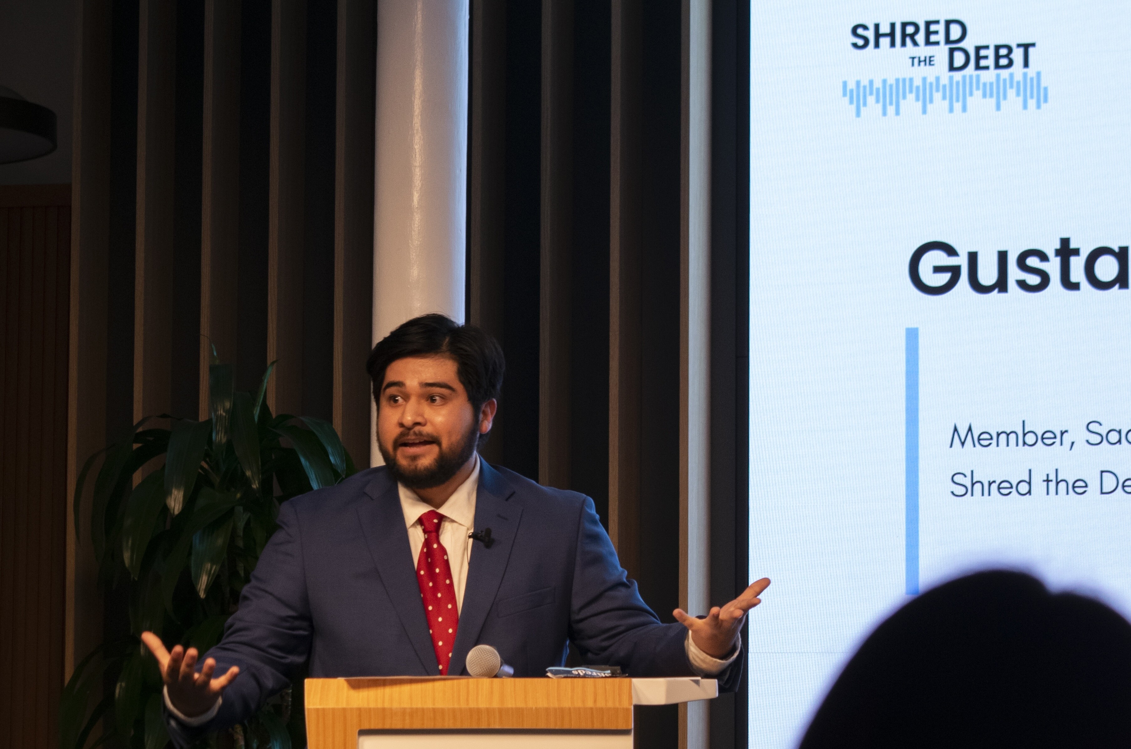 Gustavo Garcia presenting Shred the Debt at a project kickoff event
