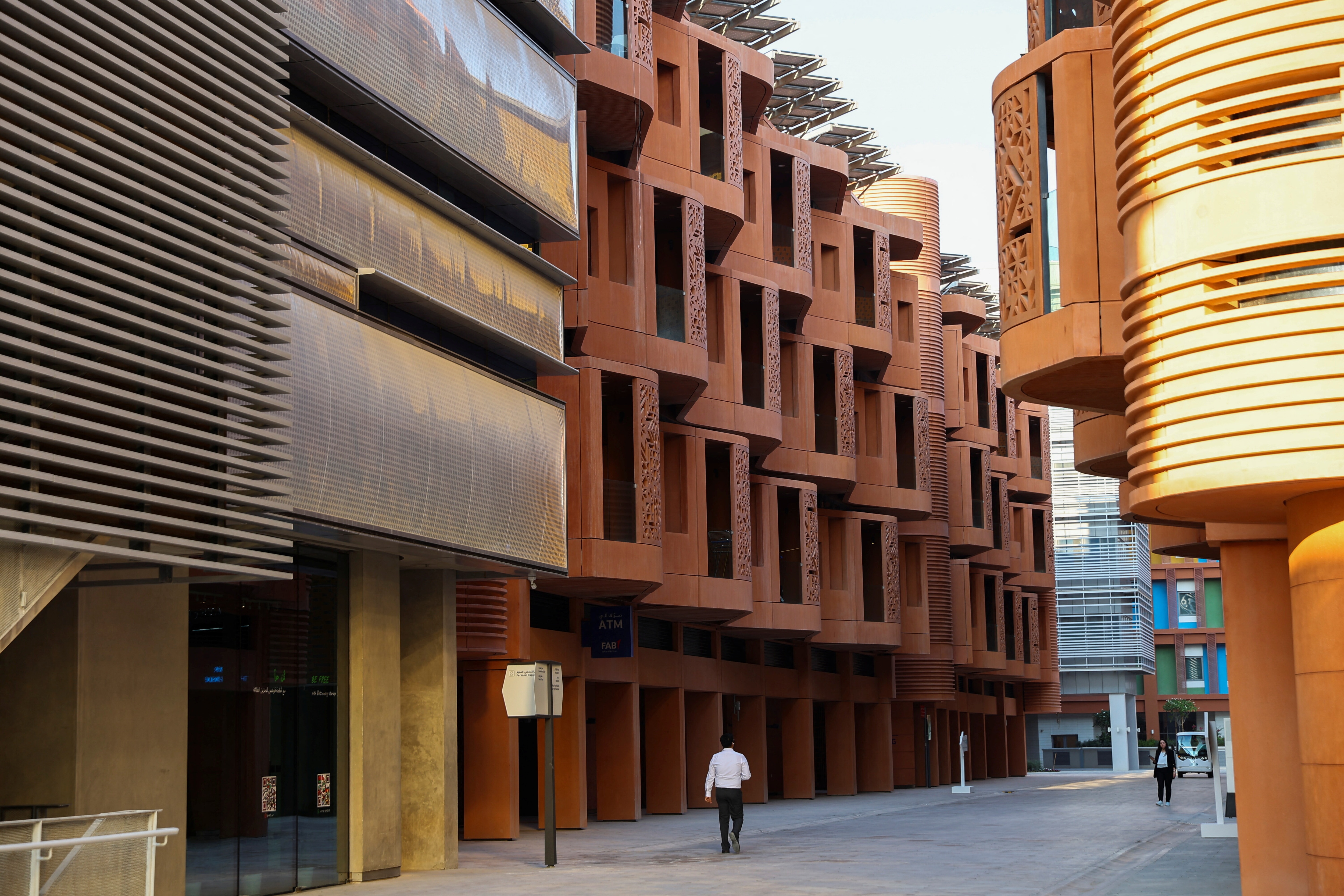 People walk at Masdar City in Abu Dhabi, United Arab Emirates, November 6, 2023
