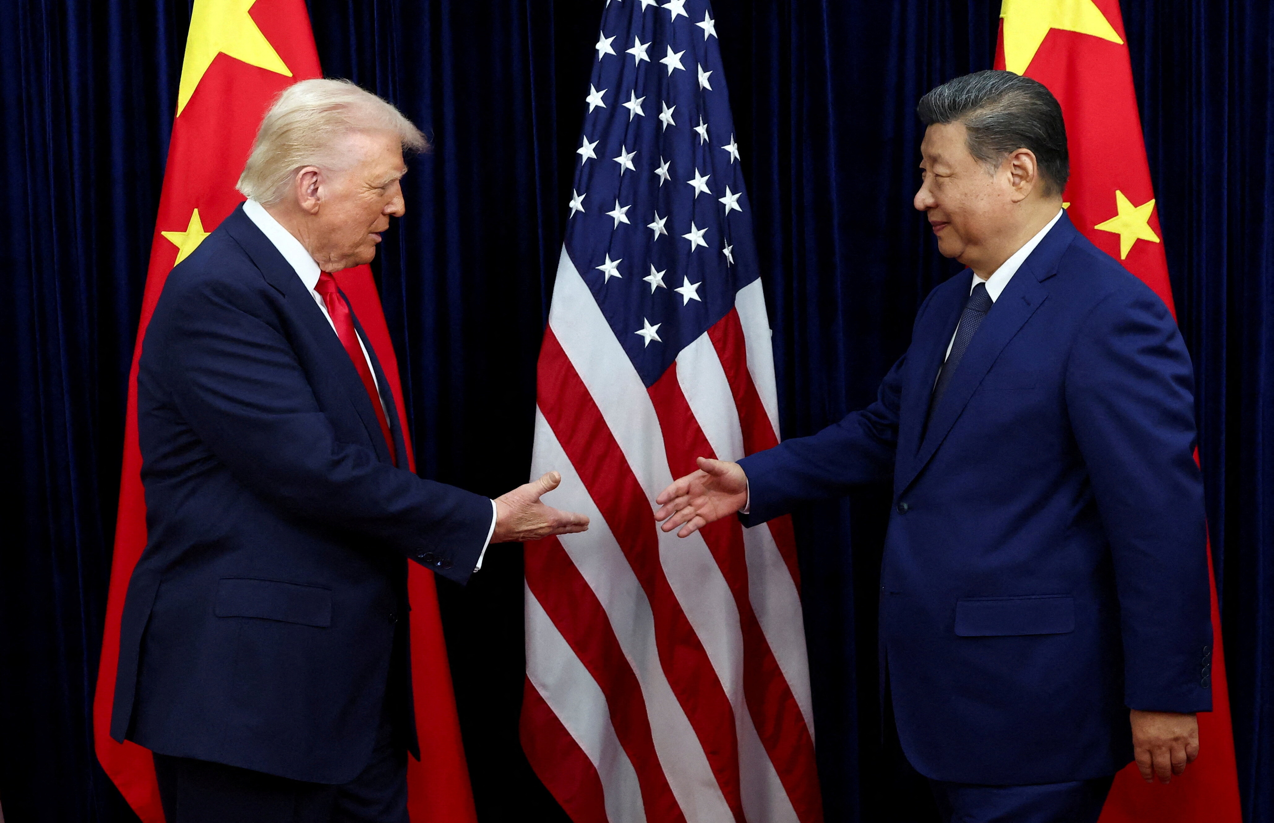 FILE PHOTO: U.S. President Donald Trump shakes hands with Chinese President Xi Jinping as they hold a bilateral meeting at Gimhae International Airport, on the sidelines of the Asia-Pacific Economic Cooperation (APEC) summit, in Busan, South Korea, October 30, 2025. REUTERS/Evelyn Hockstein/File Photo