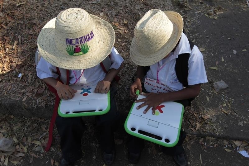  Schoolchildren use their XO laptops at the Municipal Stadium in Ciudad Sandino, on the outskirts of Managua, April 4, 2013. Around 3,000 schoolchildren will benefit from the delivery of the laptops, which were donated by the Zamora-Teran Foundation.   