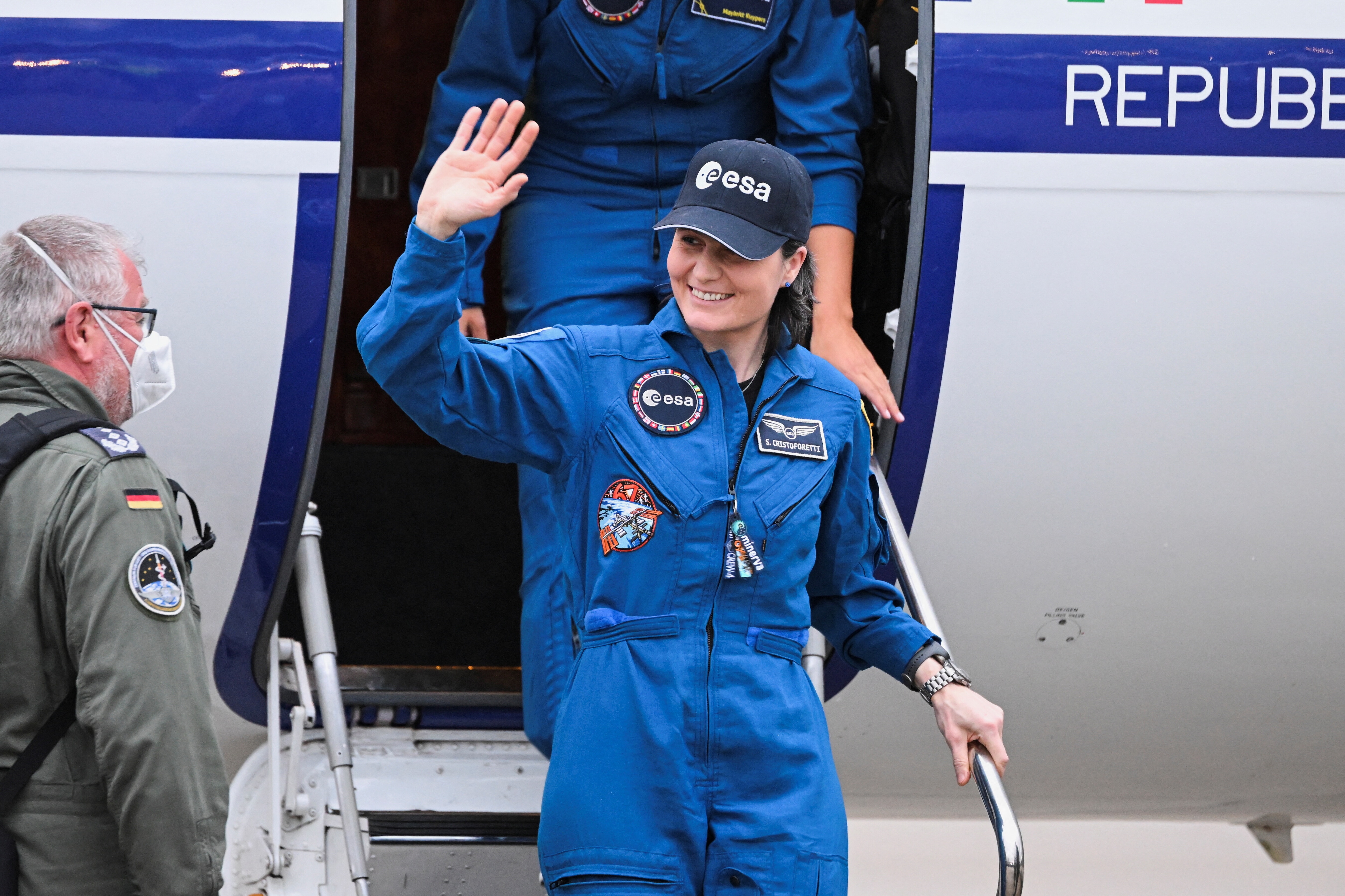 Italian ESA astronaut Samantha Cristoforetti waves as she disembarks a plane upon her arrival at the Cologne-Bonn airport following her mission and so-called 
