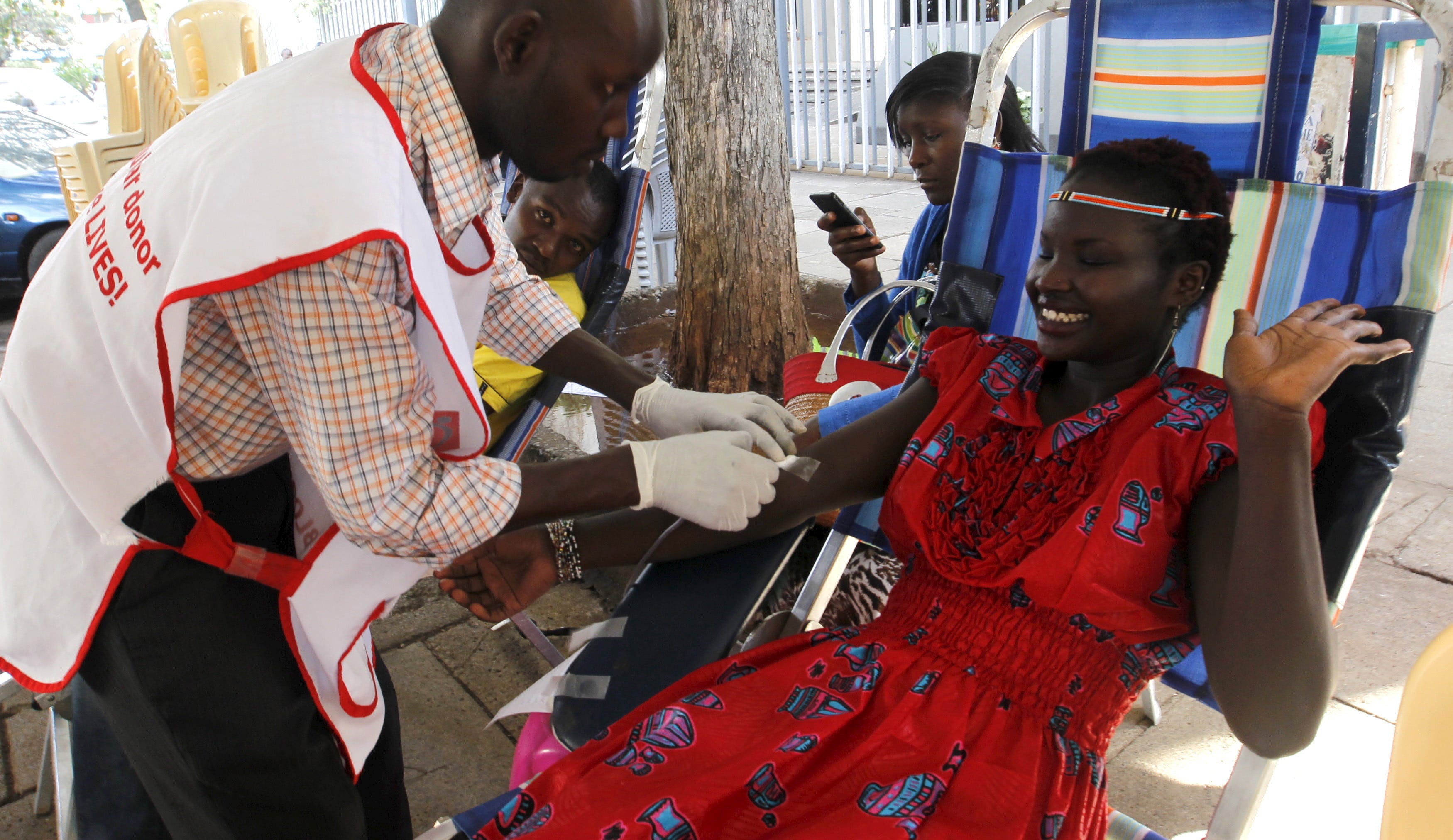 A woman donates blood in Kenya.           