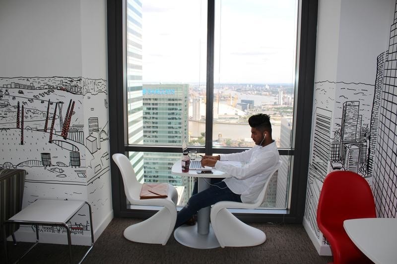 A man uses a laptop in the Level39 FinTech hub based in the One Canada Square tower of the Canary Wharf district of London, Britain, August 5, 2016.