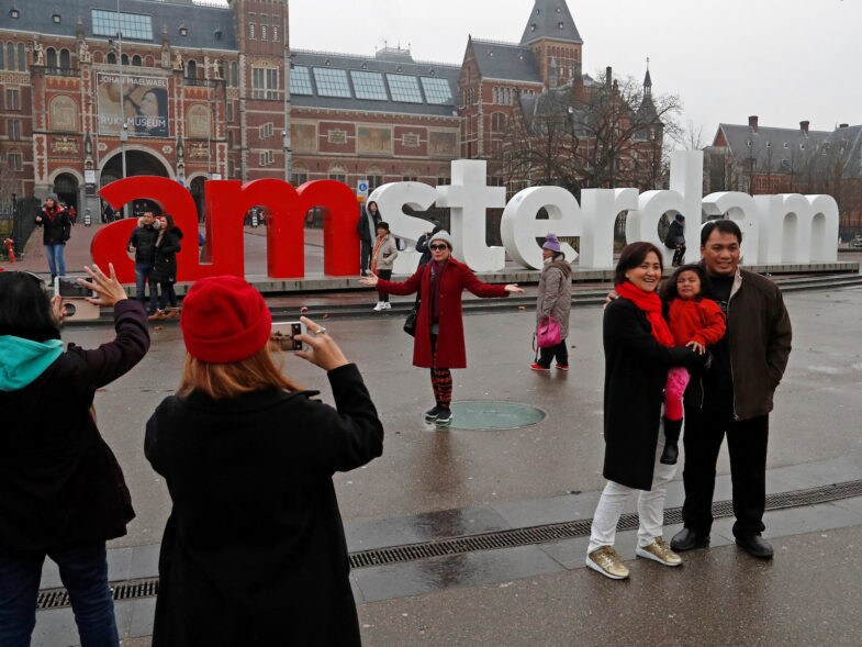 FILE PHOTO: Tourists pose for photos outside the Rijksmuseum in central Amsterdam, Netherlands, December 1, 2017. REUTERS/Yves Herman/File Photo