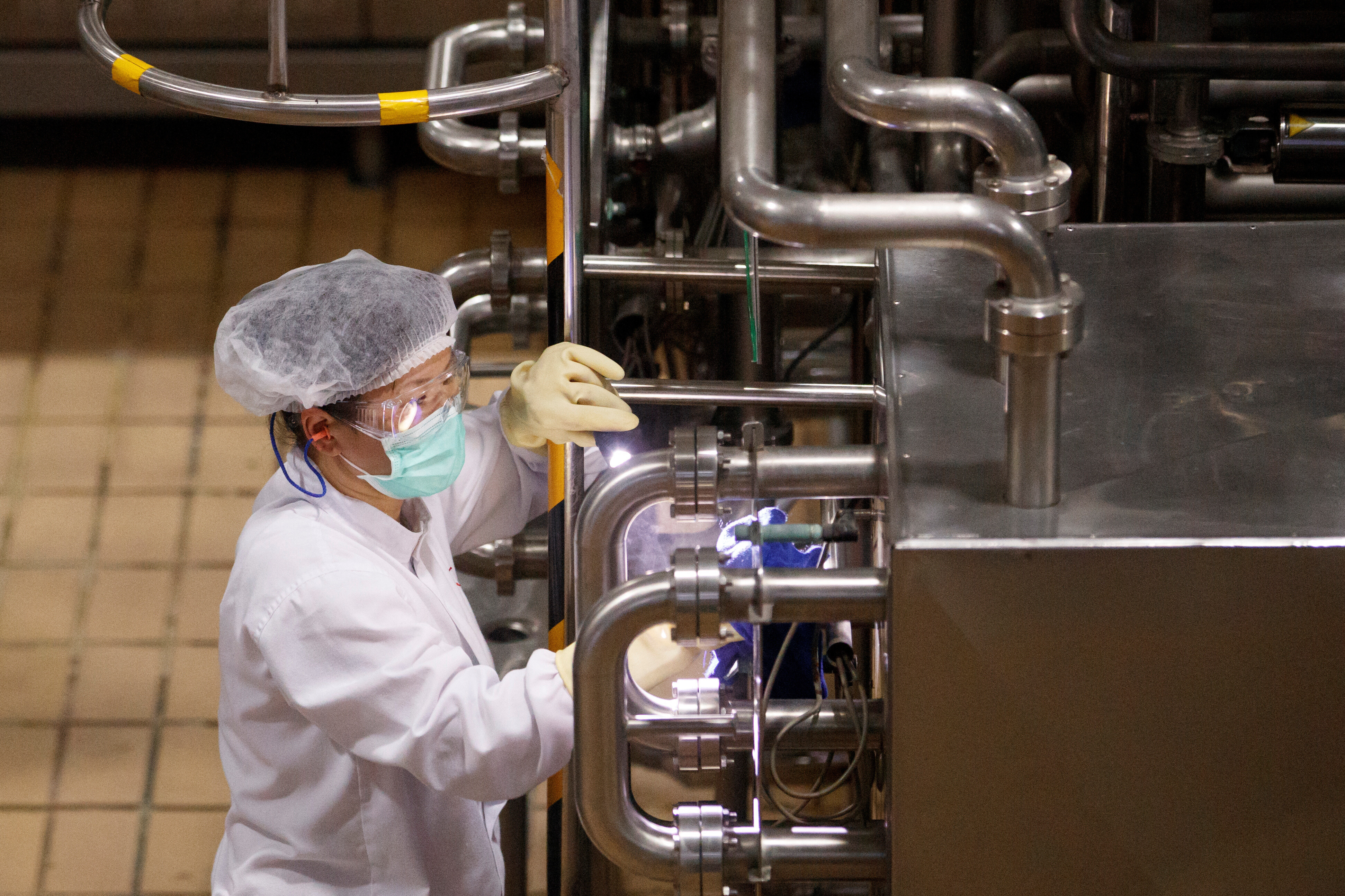 A worker wearing a face mask is seen during a government-organized tour of the Mengniu Dairy factory in Beijing as the country is hit by an outbreak of the novel coronavirus, China, February 27, 2020
