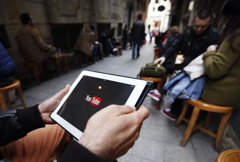 A man tries to get connected to the youtube web site with his tablet at a cafe in Istanbul March 27, 2014.