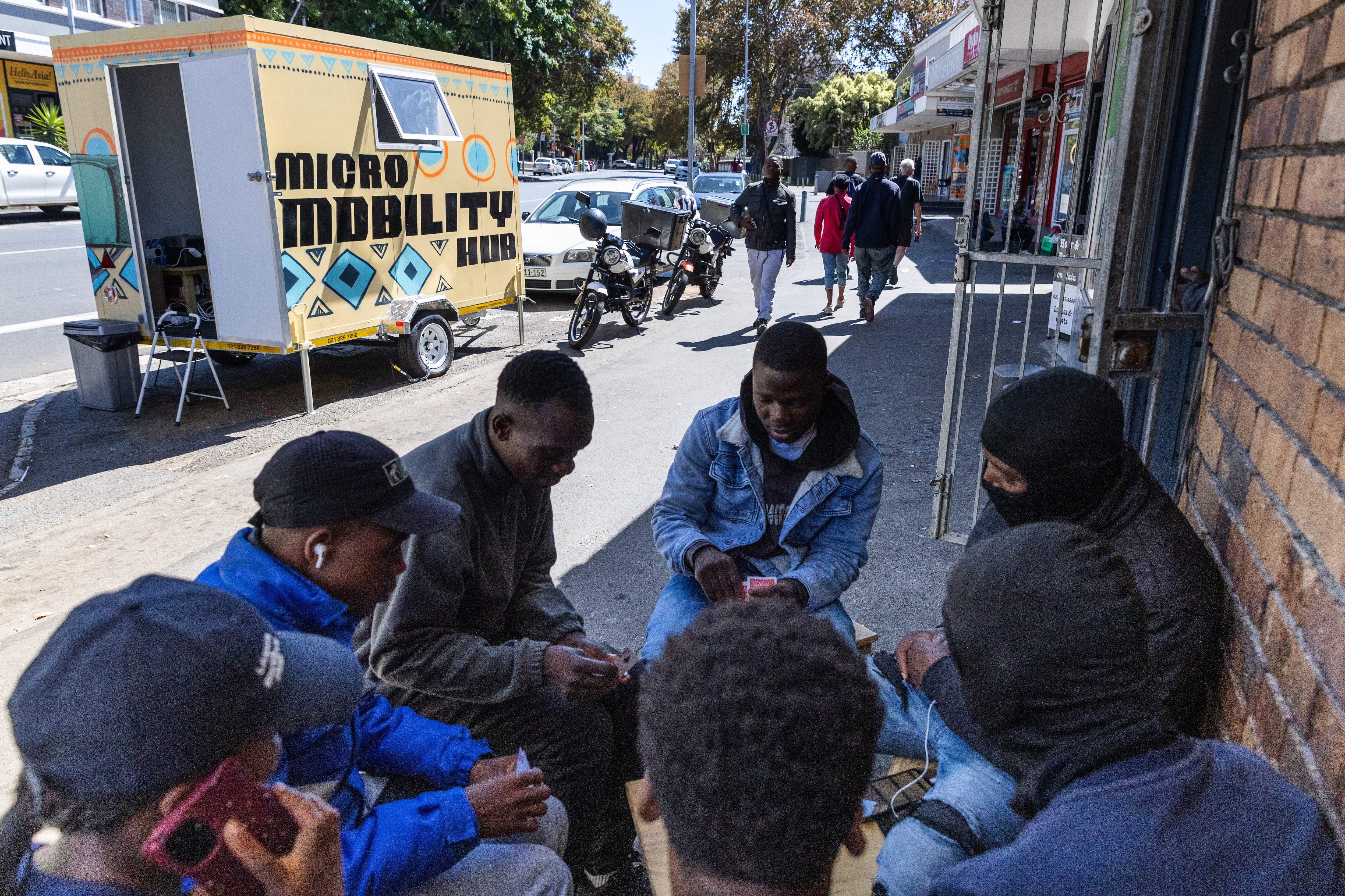 Delivery drivers take a break by a micro mobility hub in Cape Town, South Africa.
