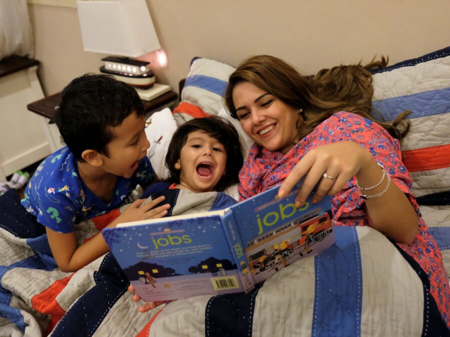 Amirah al-Turkistani, a graphic design lecturer at Jeddah University, reads a bedtime story to her children at her house in Jeddah, Saudi Arabia, October 23, 2017. REUTERS/Reem Baeshen SEARCH