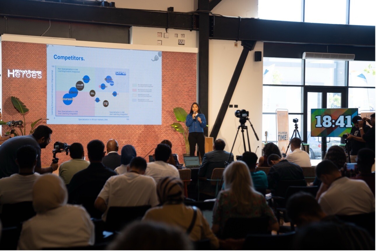 A woman presents to a full room.