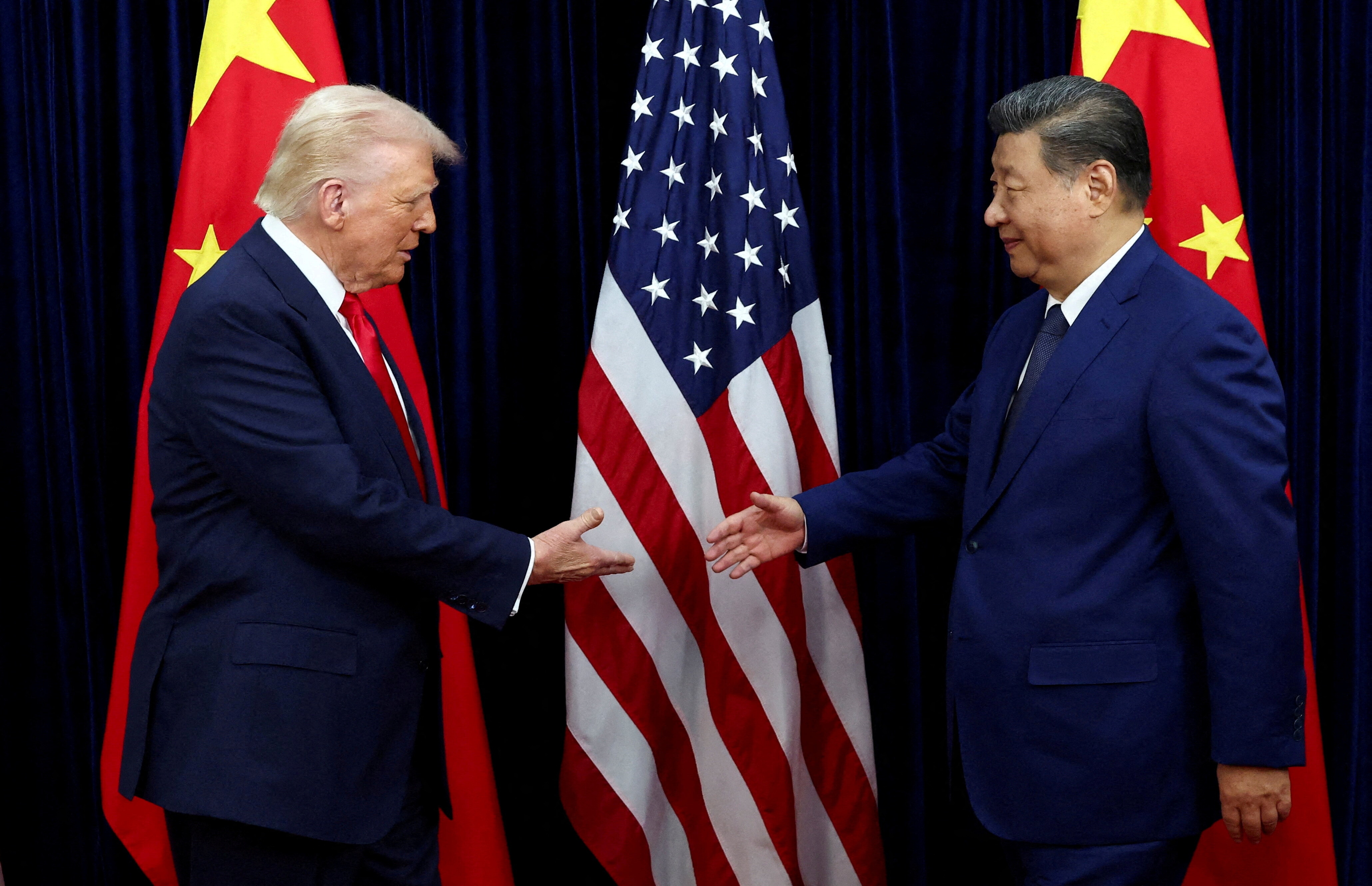 FILE PHOTO: U.S. President Donald Trump shakes hands with Chinese President Xi Jinping as they hold a bilateral meeting at Gimhae International Airport, on the sidelines of the Asia-Pacific Economic Cooperation (APEC) summit, in Busan, South Korea, October 30, 2025. REUTERS/Evelyn Hockstein//File Photo