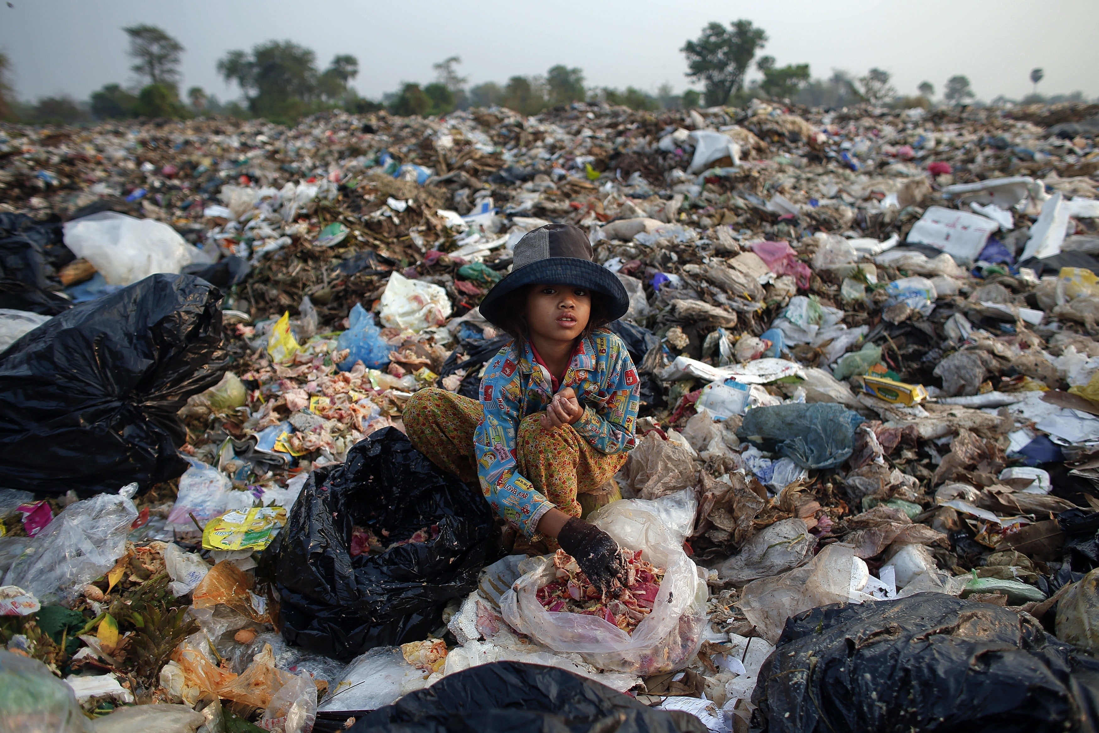 Soburn, an 11-year-old girl, collects what can be used as food for pigs at landfill dumpsite outside Siem Reap March 19, 2015. A second-grade student, she helps her parents in the morning collecting usable items at the dumpsite where they live before going to school in the afternoon. Anlong Pi, an eight-hectare dumpsite situated close to the famous Cambodian resort province of Siem Reap, has recently become a tourist attraction in its own right. Sightseers pose for pictures with children who scavenge scraps for a living, making between $0.25 and $2 per day, according to a representative of a company overseeing the waste. Michelle Obama is due to visit to Cambodia to promote Let Girls Learn, a worldwide initiative that aims to help adolescent girls attend school.   REUTERS/Athit PerawongmethaPICTURE 8 OF 23 FOR WIDER IMAGE STORY 'LIVING ON RUBBISH'SEARCH 'ANLONG PI' FOR ALL IMAGES - RTR4U4KB   