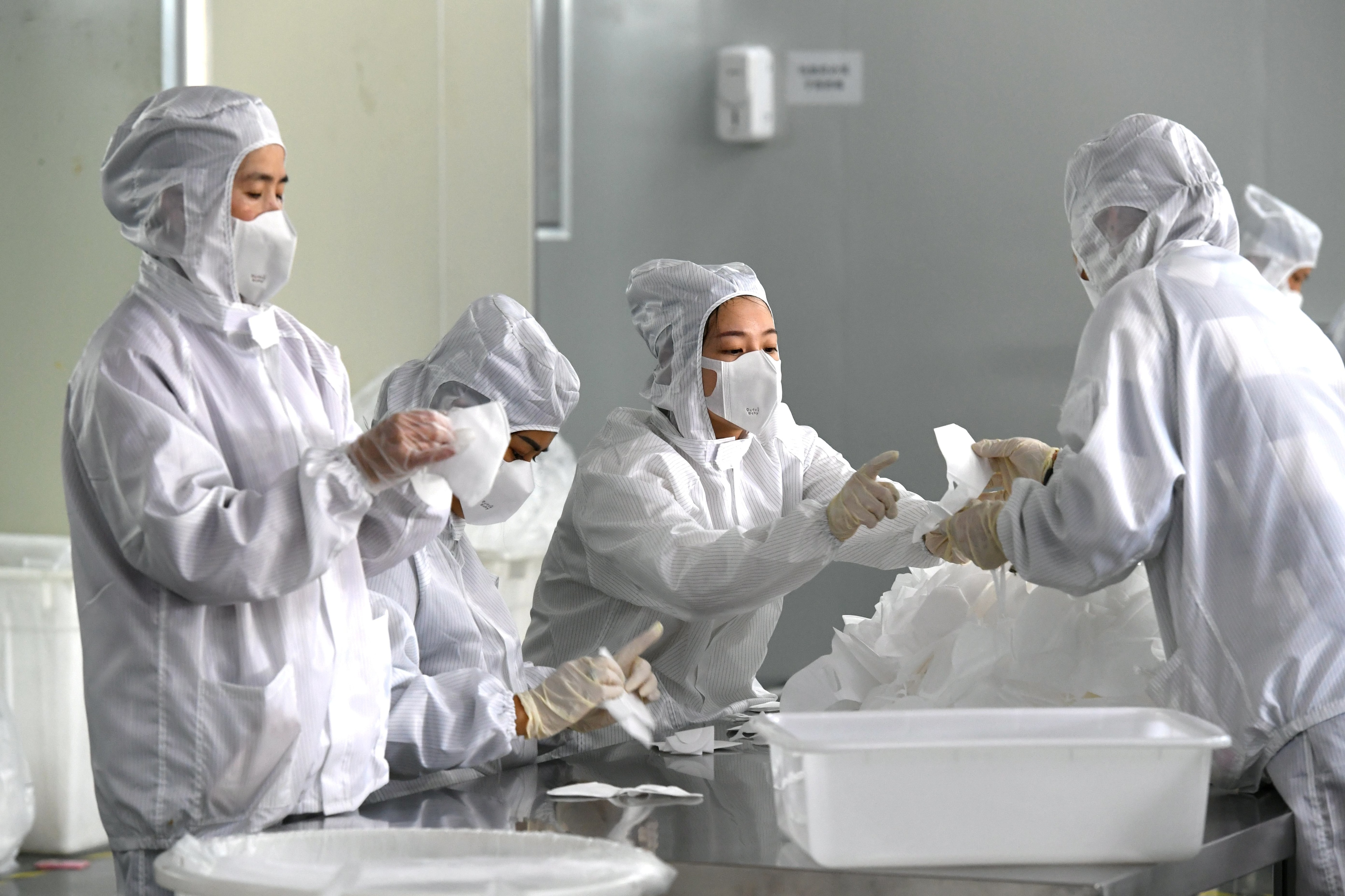 Employees work on a production line manufacturing face masks at a factory, as the country is hit by an outbreak of the novel coronavirus, in Fuzhou, Fujian province, China February 15, 2020. cnsphoto via REUTERS   ATTENTION EDITORS - THIS IMAGE WAS PROVIDED BY A THIRD PARTY. CHINA OUT. - RC2V0F9JUYKQ