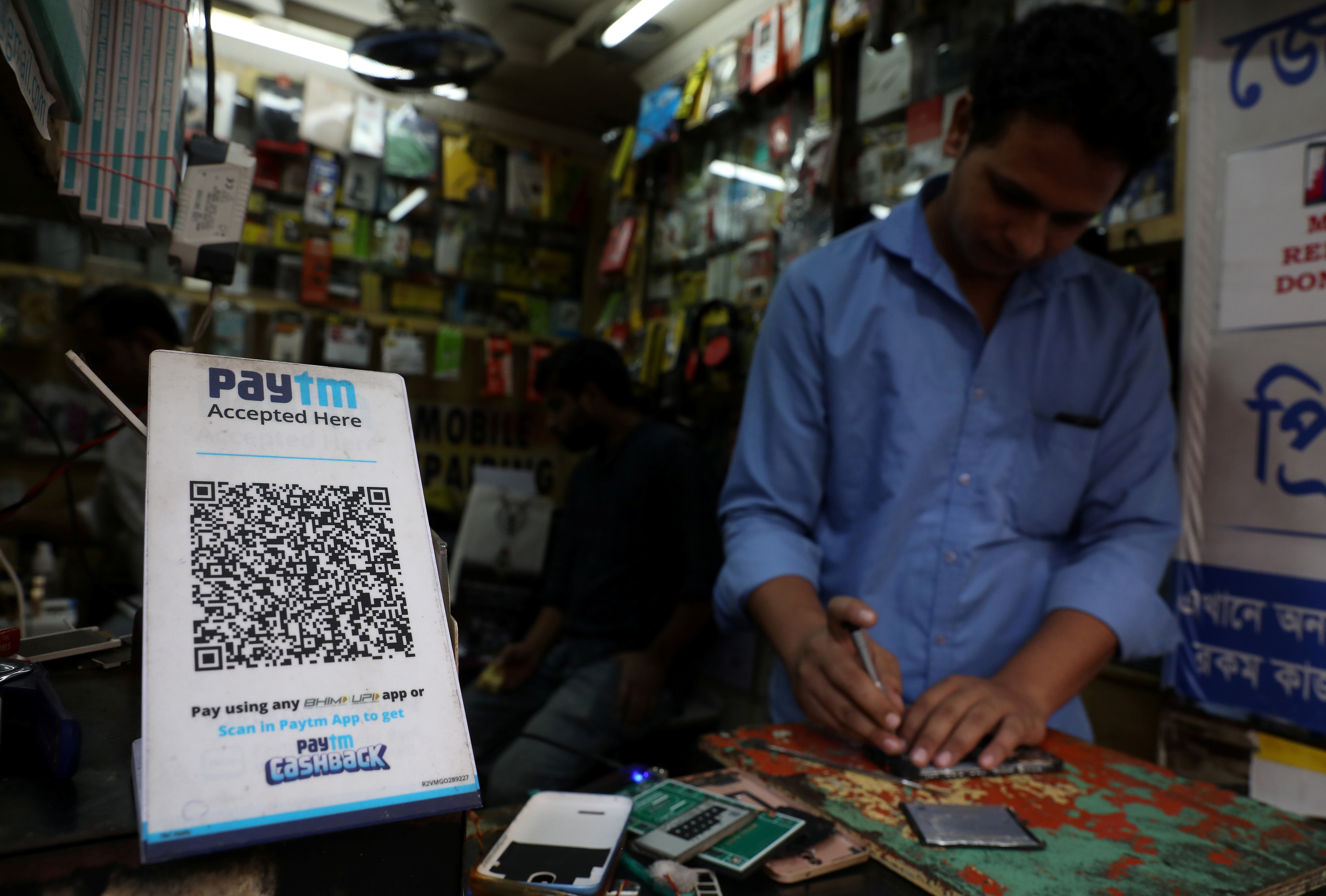 A QR code of Paytm, which uses UPI, is seen at a mobile repairing shop in Kolkata, India, November 9, 2021