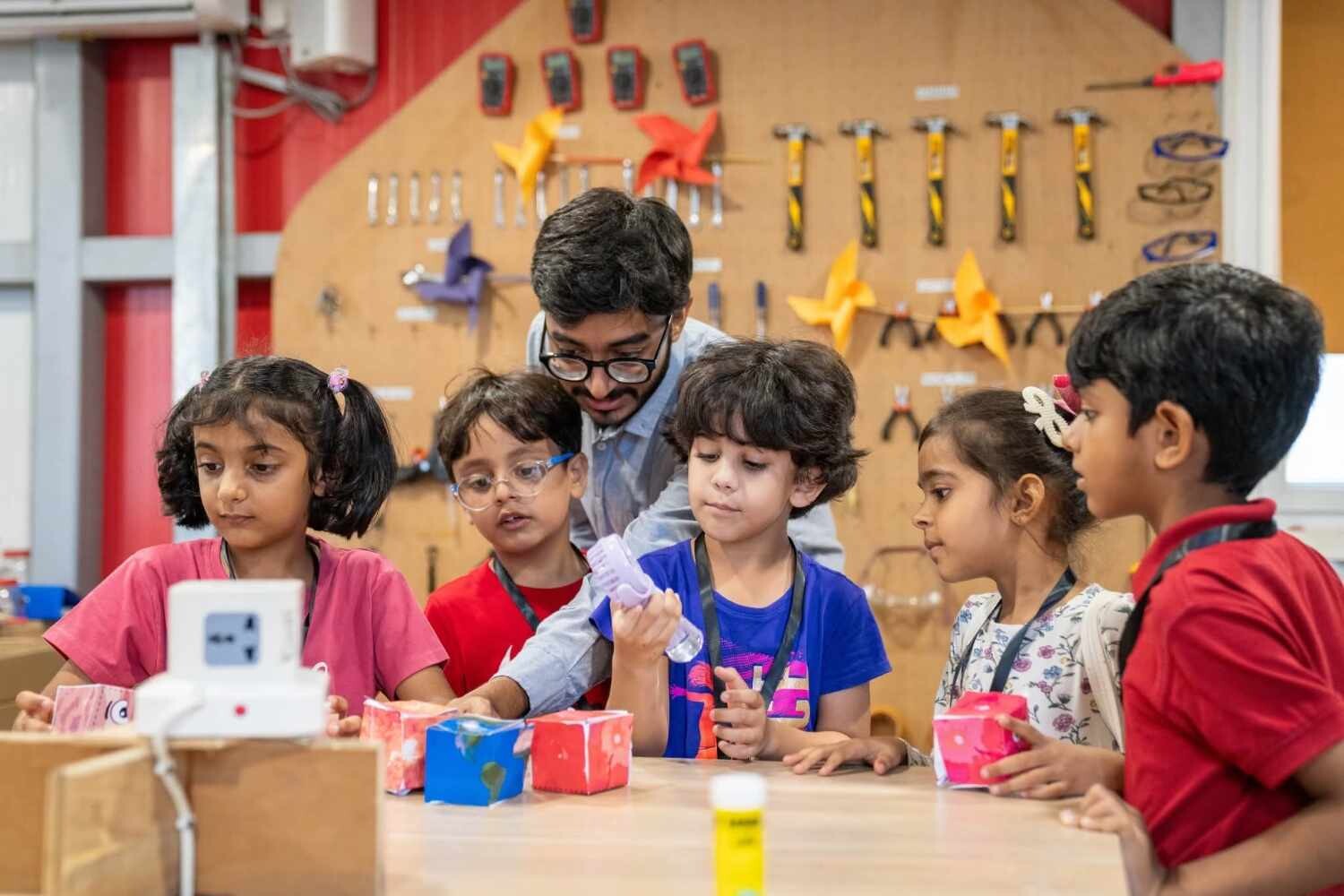 Children watch and take part in a science experiment.