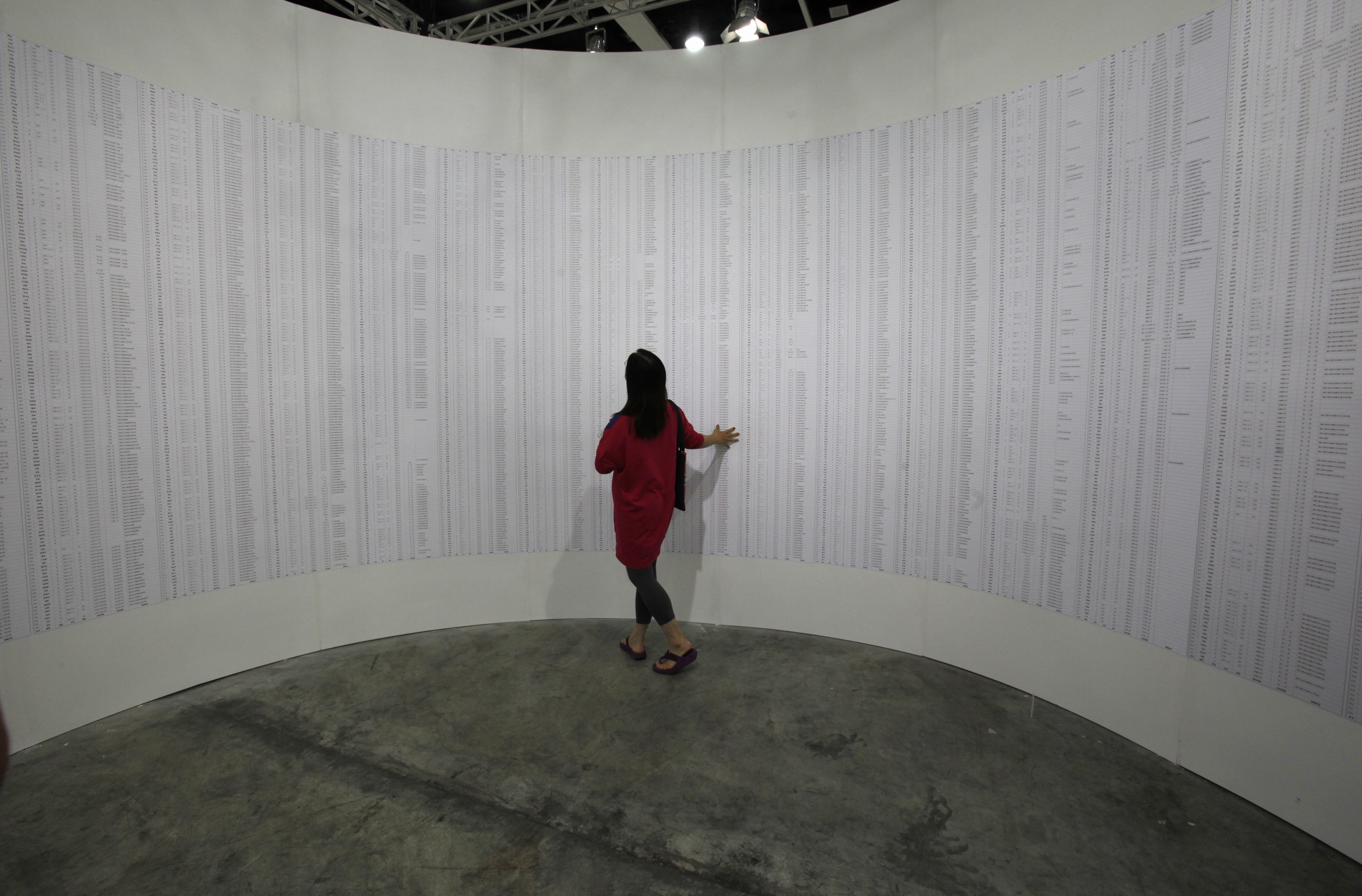 A visitor looks at the interior portion of an artwork titled    