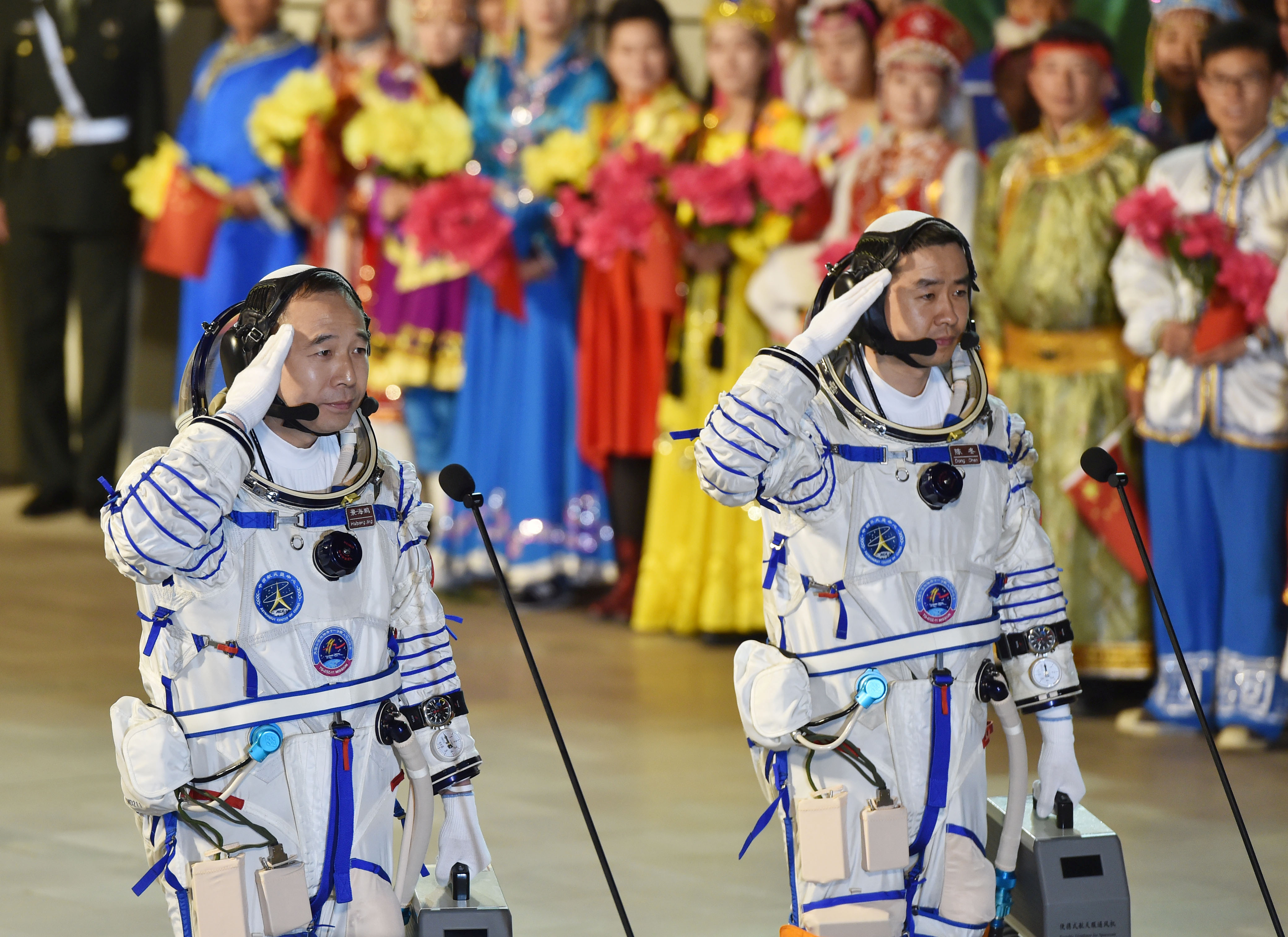 Chinese astronauts Jing Haipeng (L), Chen Dong salute before the launch of  Shenzhou-11 manned spacecraft, in Jiuquan, China, October 17, 2016. China Daily/via REUTERS ATTENTION EDITORS - THIS PICTURE WAS PROVIDED BY A THIRD PARTY. EDITORIAL USE ONLY. CHINA OUT. NO COMMERCIAL OR EDITORIAL SALES IN CHINA.    REUTERS/Stringer CHINA OUT. NO COMMERCIAL OR EDITORIAL SALES IN CHINA - RTX2P2X7       