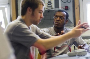 Siemens engineering apprentice Vijent of the UK an a fellow student attend a class at the Siemens training centre in Berlin